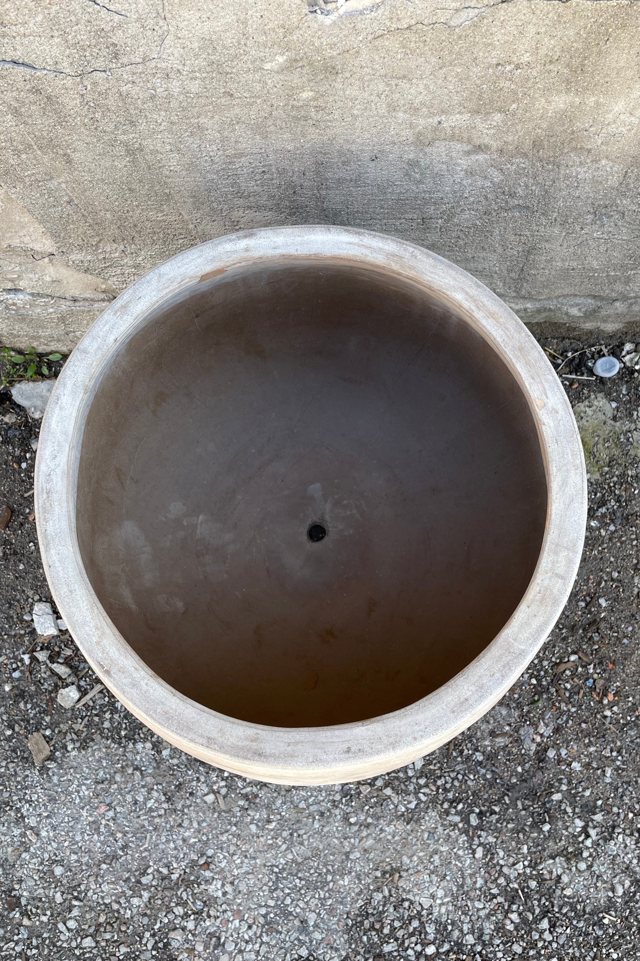 Detail of the inside of the Yumiko Unglazed Planter Large against a grey wall
