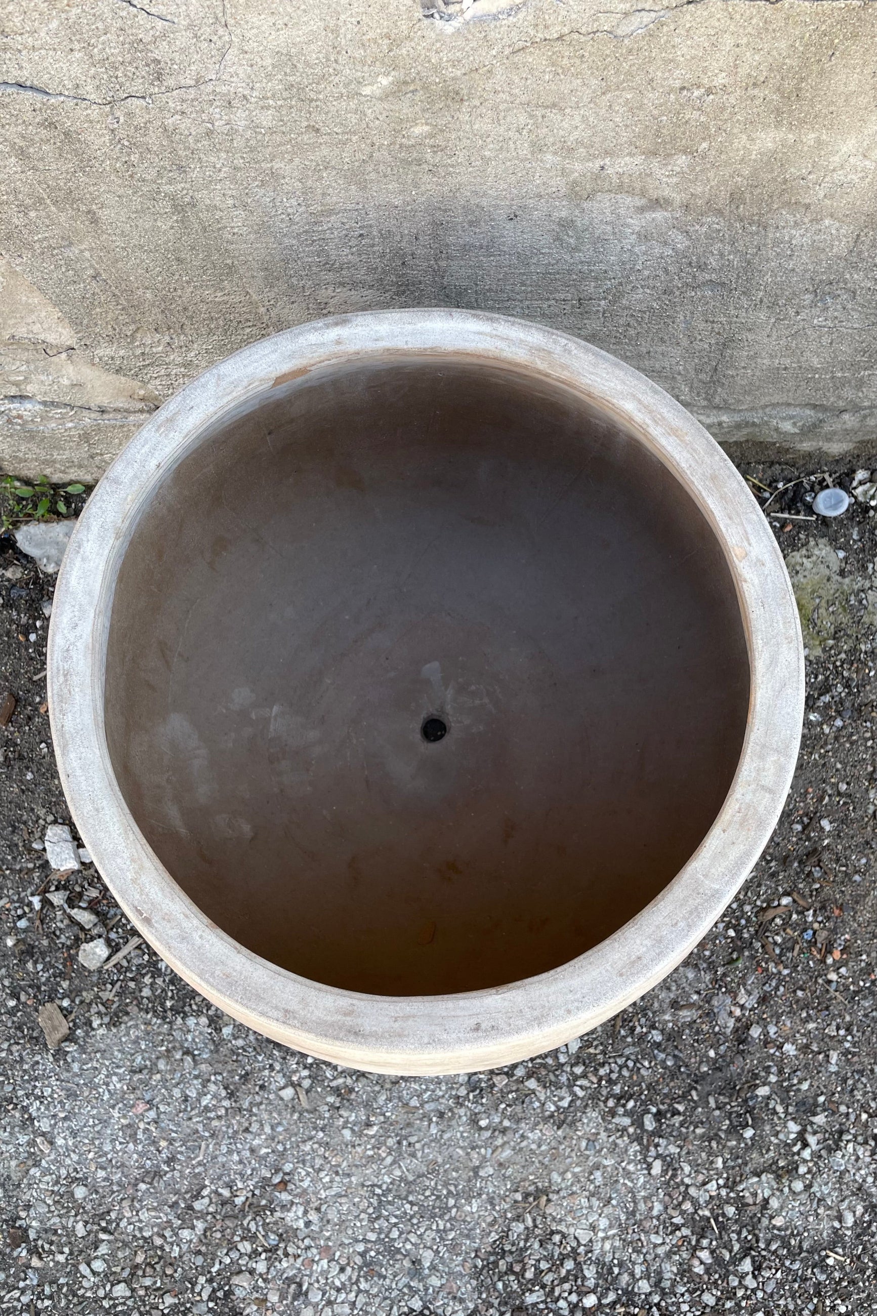 Detail of the inside of the Yumiko Unglazed Planter Large against a grey wall ©Sprout Home