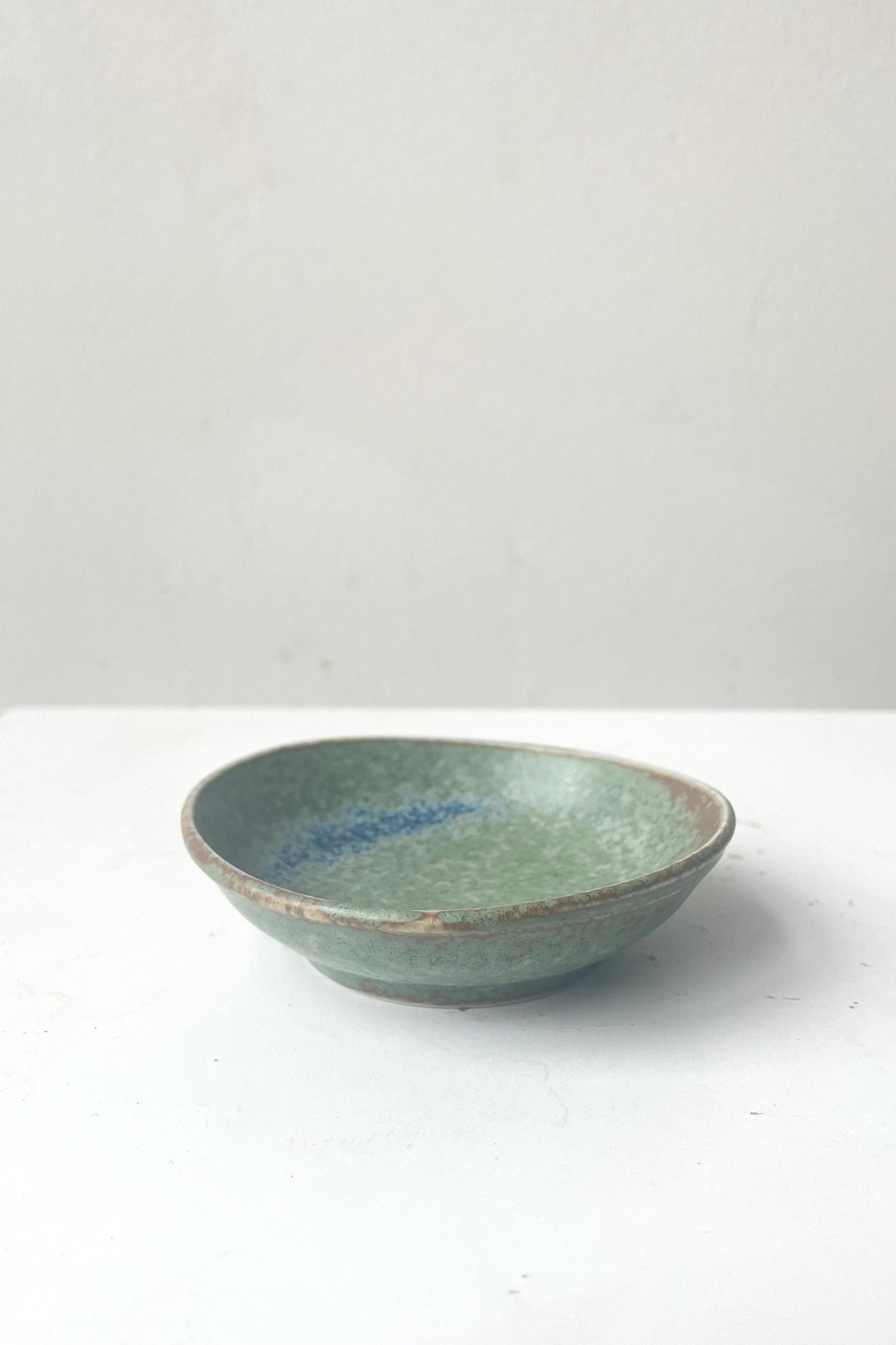 A frontal view of Sauce dish terra green against white backdrop ©Sprout Home