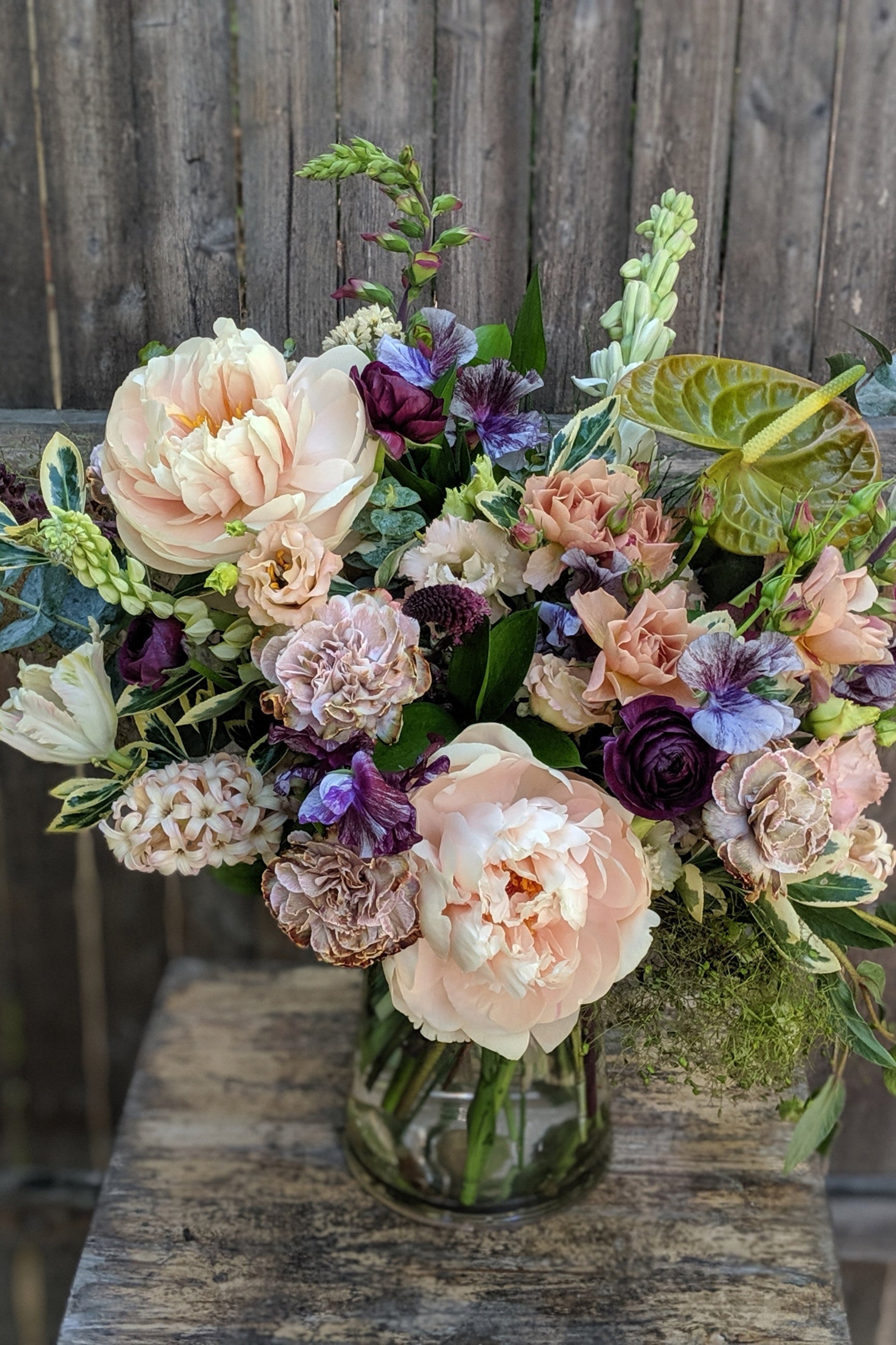 A detailed view of an example of Floral Arrangement Dusk with Peony and purple ranunculus and anthurium from Sprout Home in Chicago ©Sprout Home #size_$200