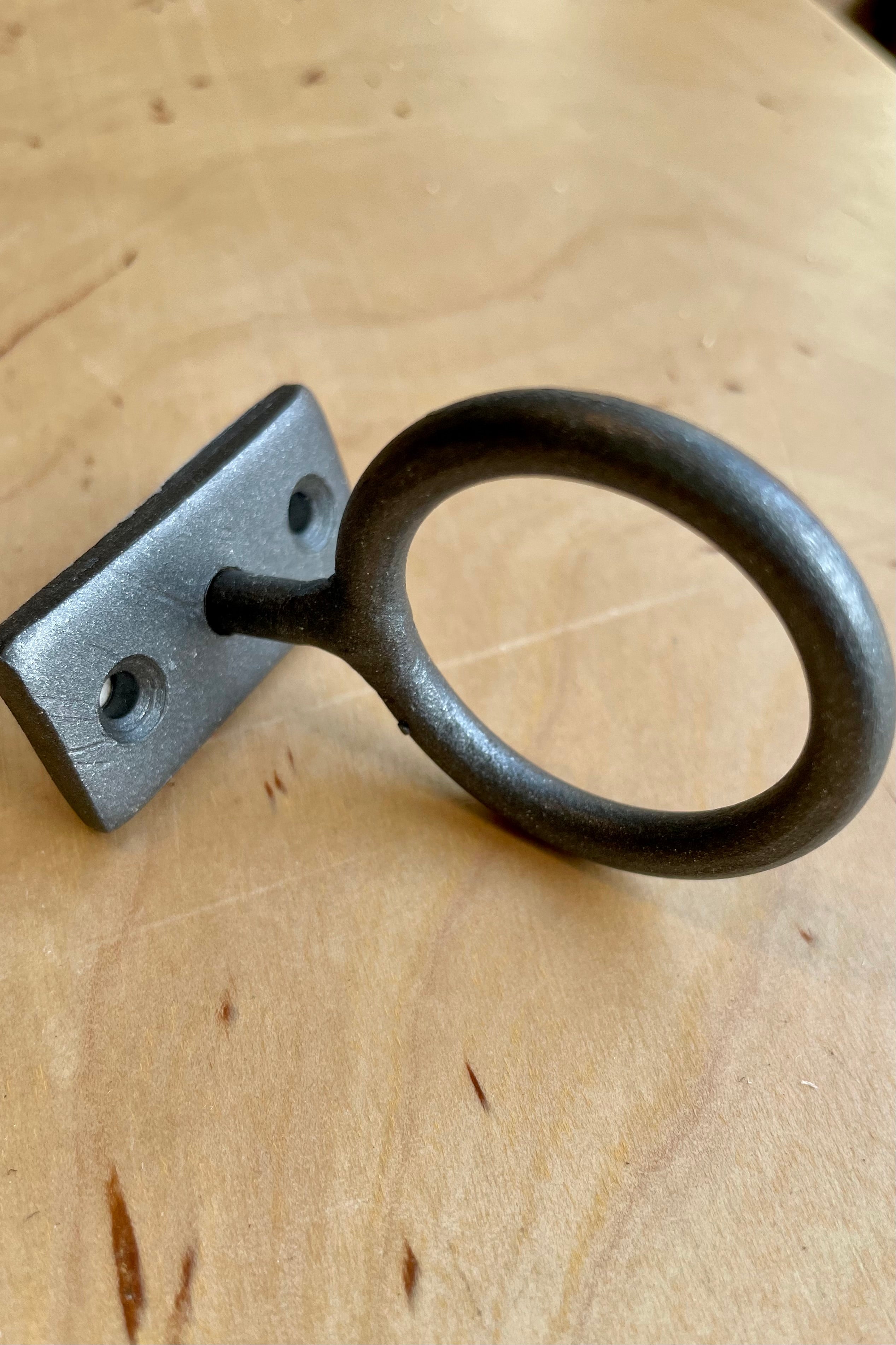 The natural grey color bijou hanging ring on a wood shelf at Sprout Home.