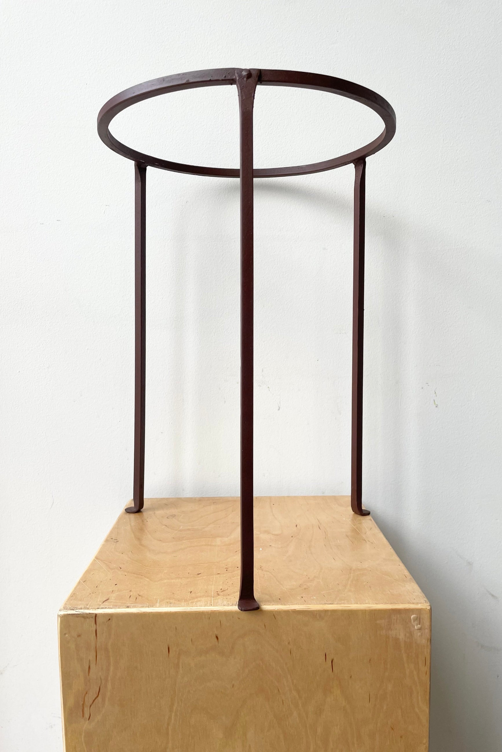 Iron Plant Stand Low 12" D x 17" H against a white wall ©Sprout Home
