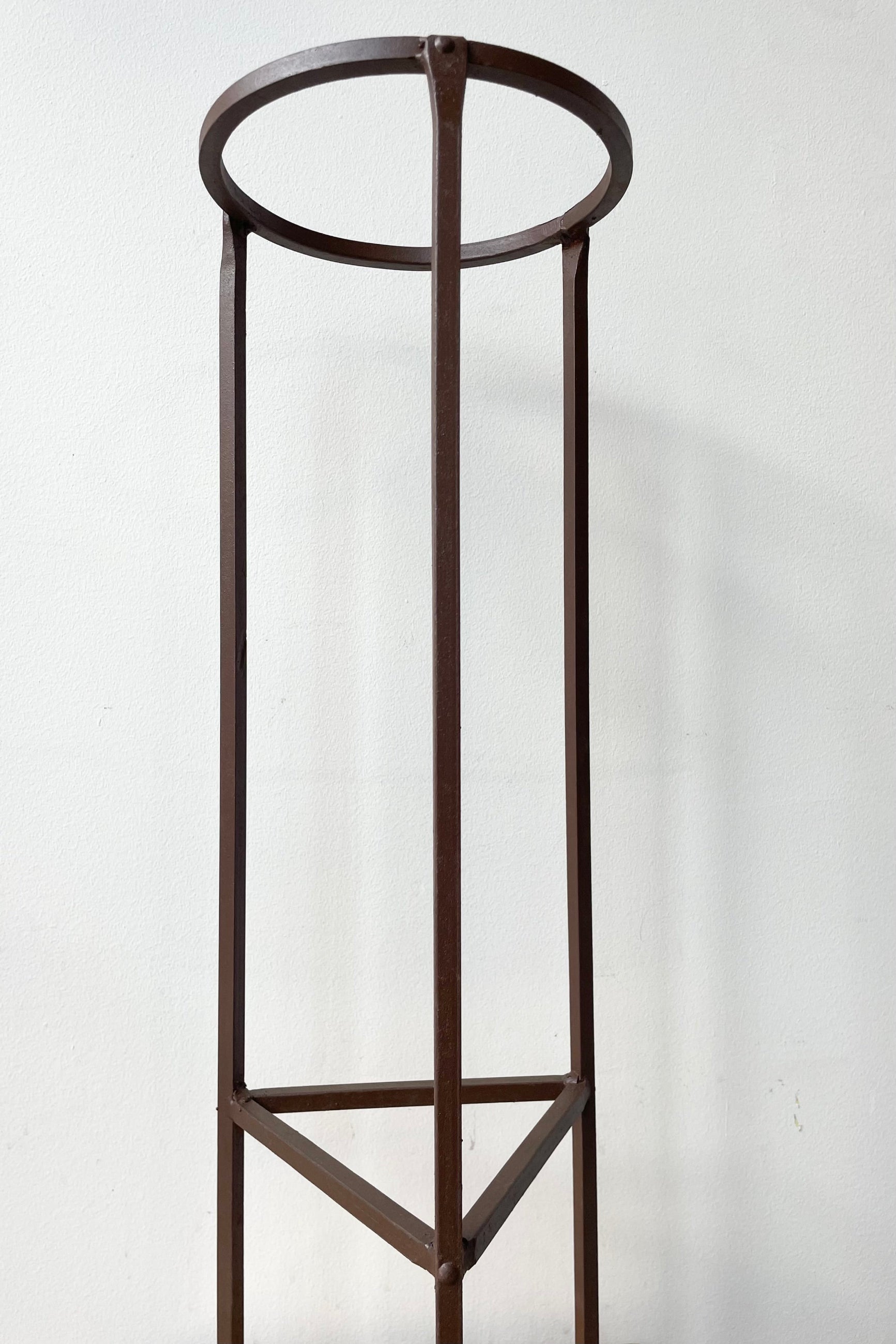 detail of Iron Plant Stand Medium 8"dia x 26.5"H against a white wall ©Sprout Home