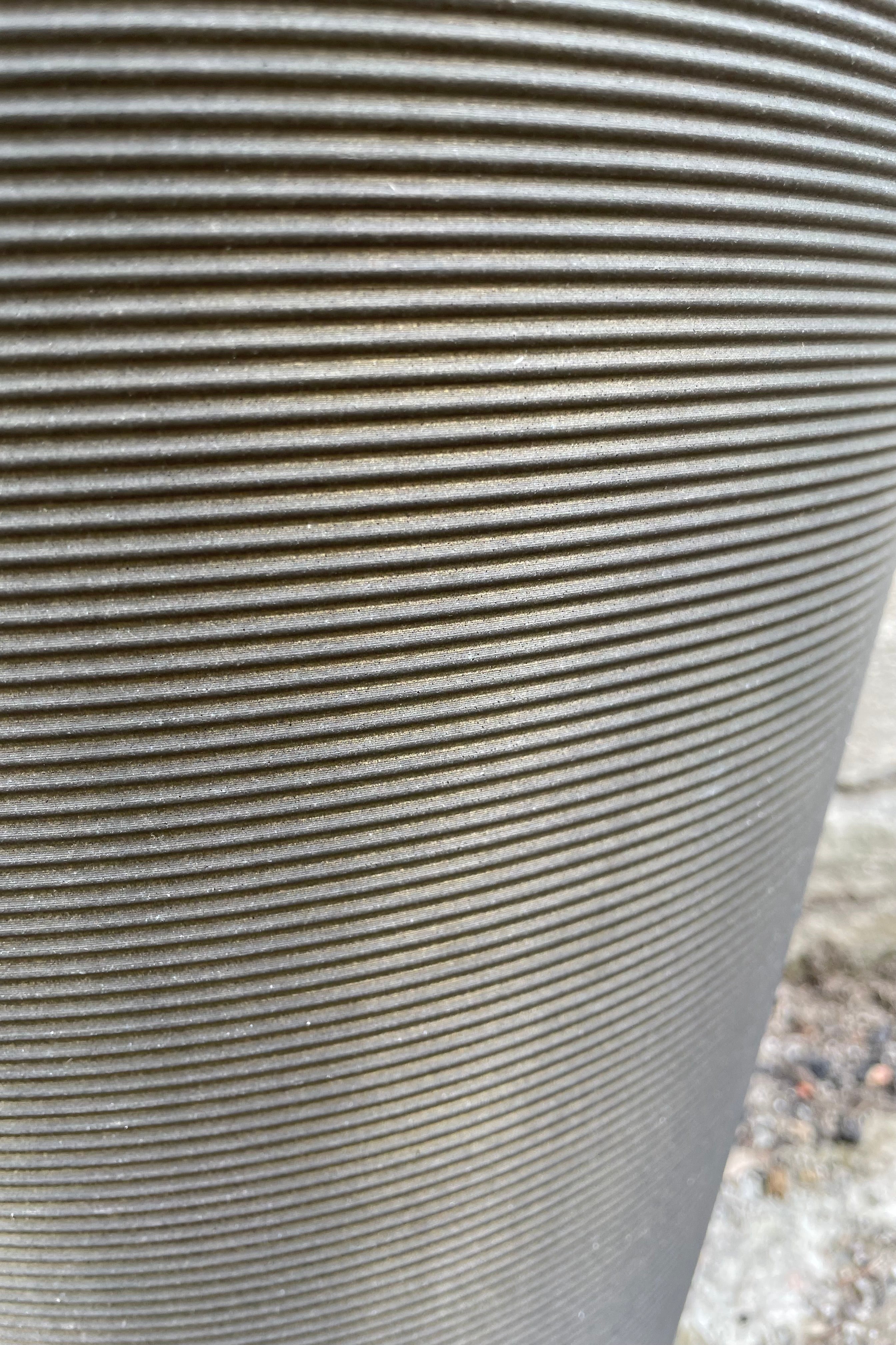 a detail picture of the horizontal banding on the old bronze madison pot.