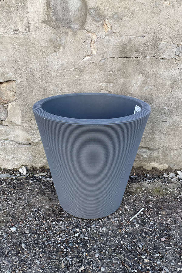 14" slate Madison planter against a concrete wall.