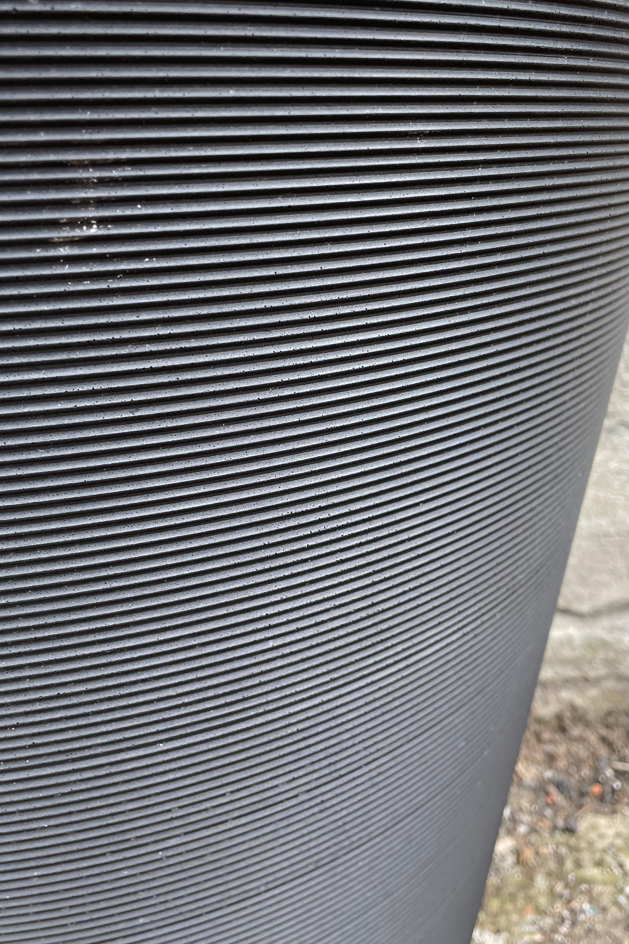 A closeup picture of the distinctive horizontal ridges of the caviar black Madison planter.
