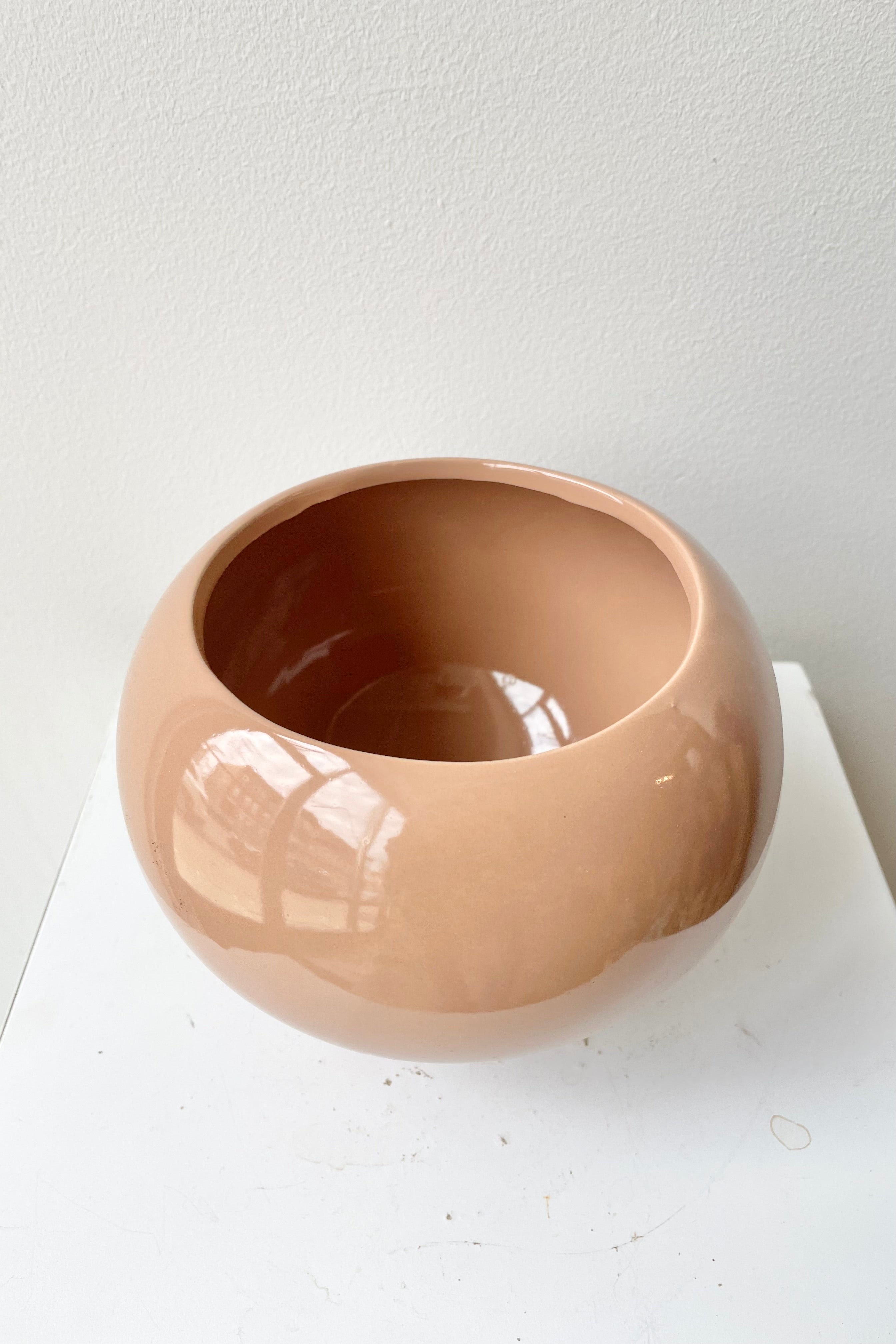 The 5" glossy nude round pot showing the inside of the vessel.