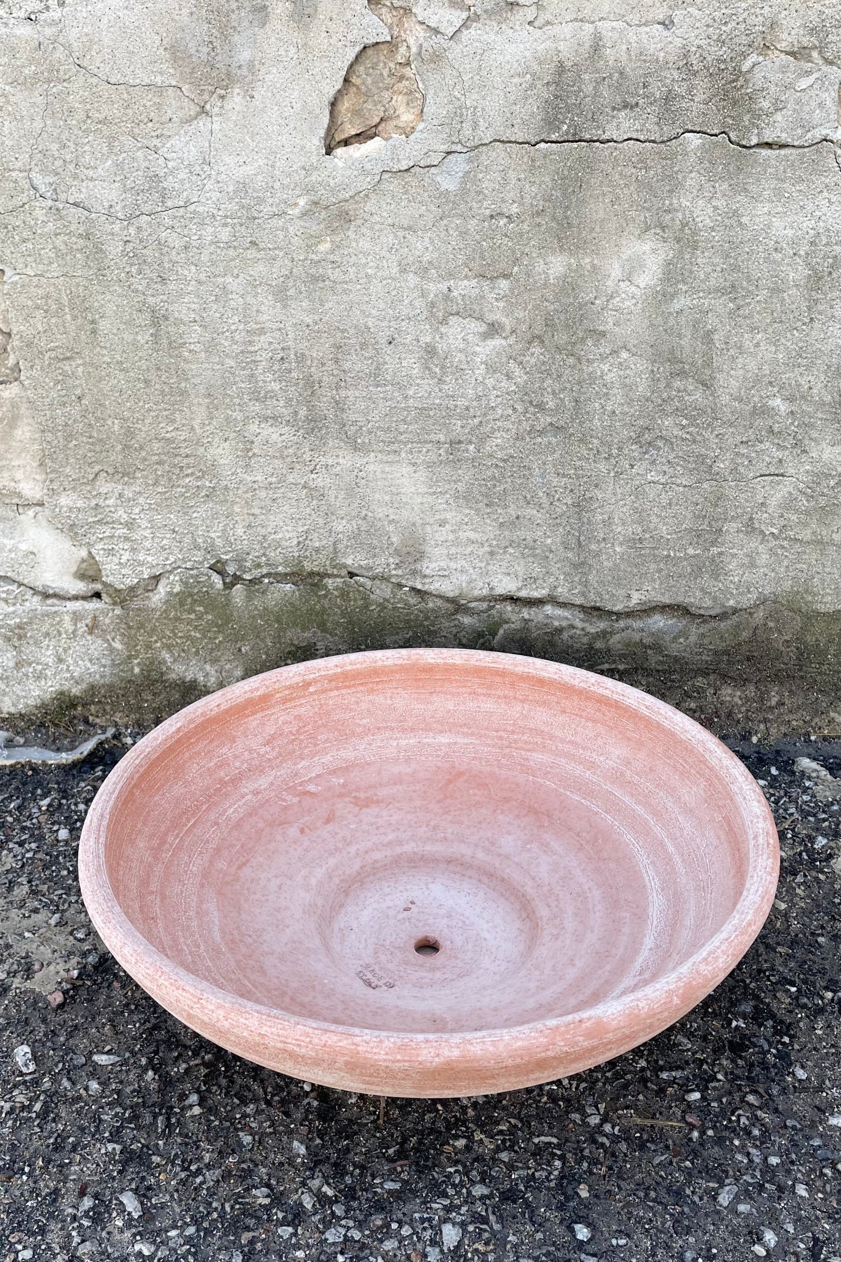 An overhead view of Ada Clay Bowl & Saucer rosa 40cm against concrete backdrop ©Sprout Home