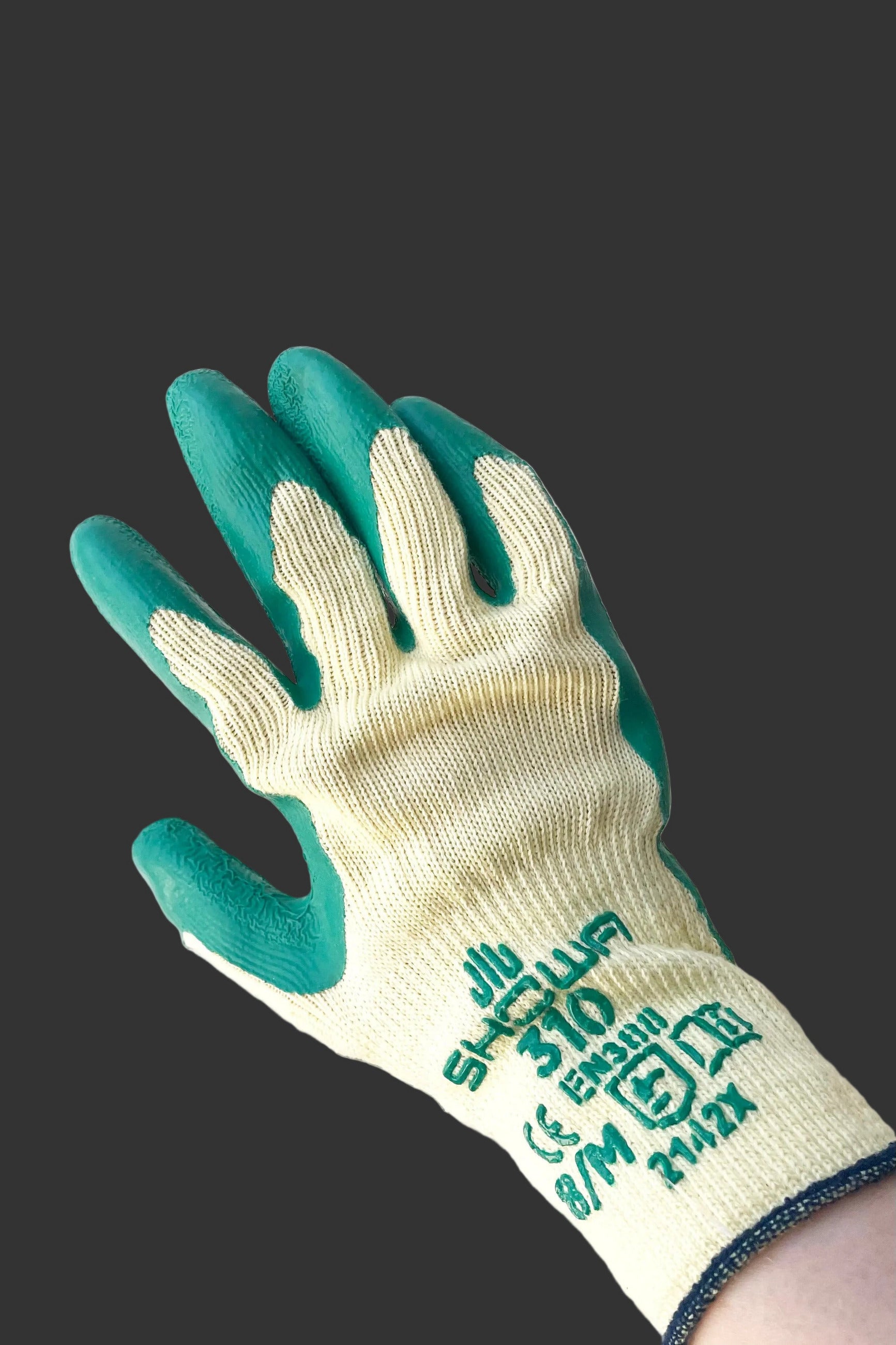 A hand dons the Atlas Super Grip Gloves Medium against white backdrop ©Sprout Home