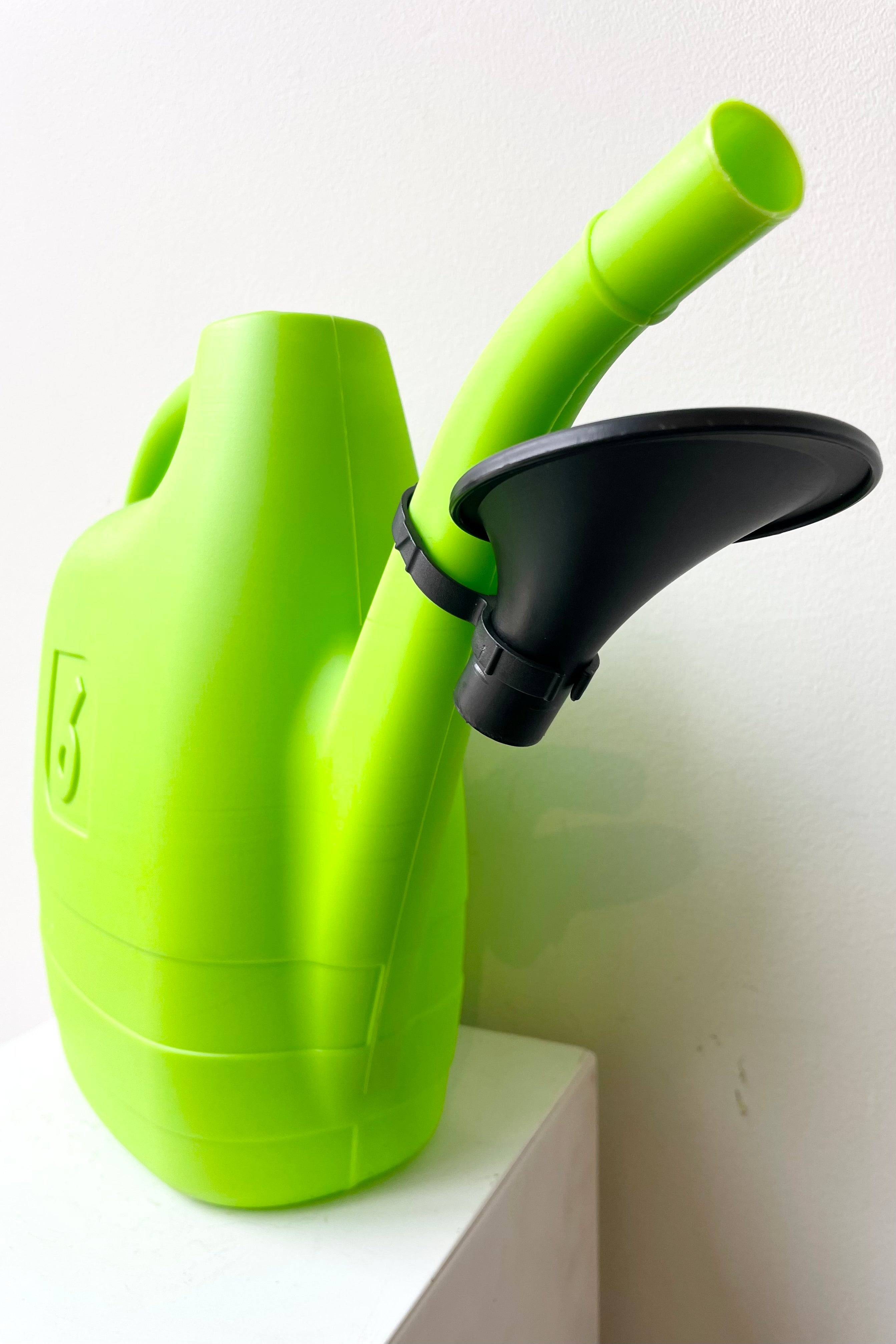 detail of the Energy Watering Can Green XL against a white wall