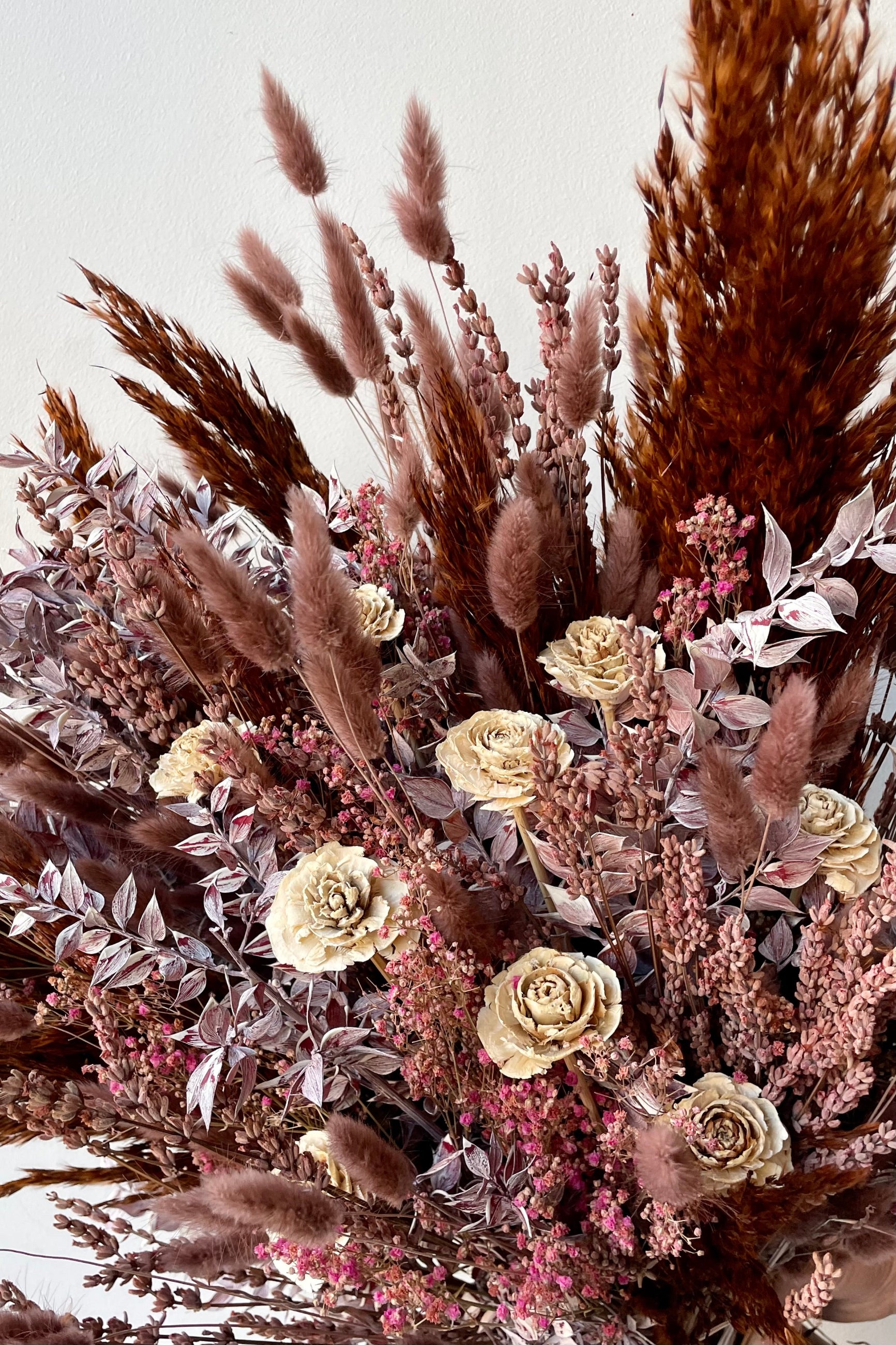 Detail image of the Sprout Home custom arrangement Ambrosia showing bunny tail, plums, rosewood flowers and ruscus ©Sprout Home #size_$200