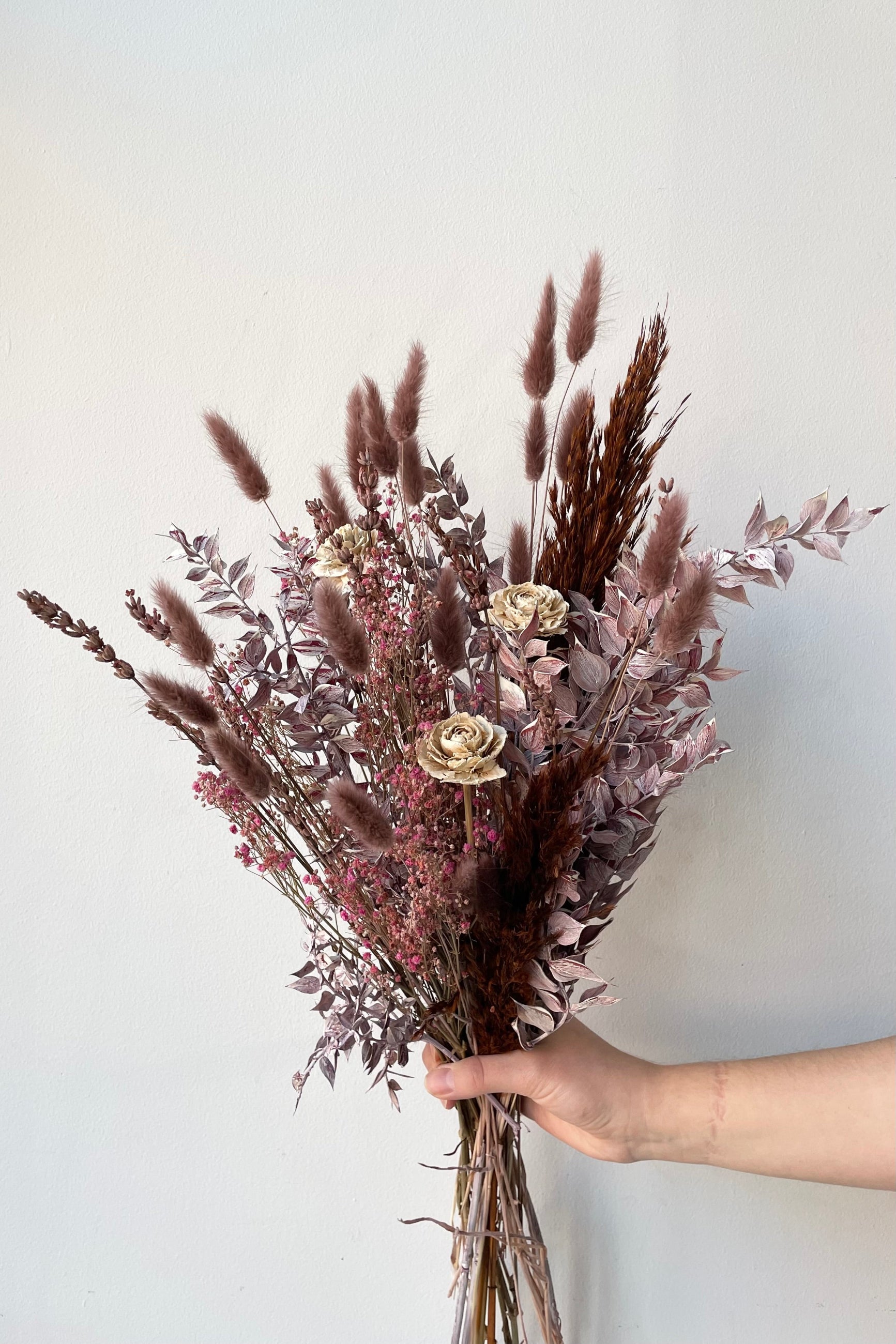 Sprout Home Ambrosia preserved arrangement being held against a white wall ©Sprout Home #size_$60