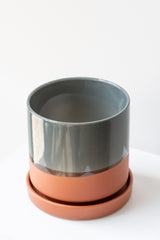 Large Terracotta Minute Pot sits on a white surface in a white room