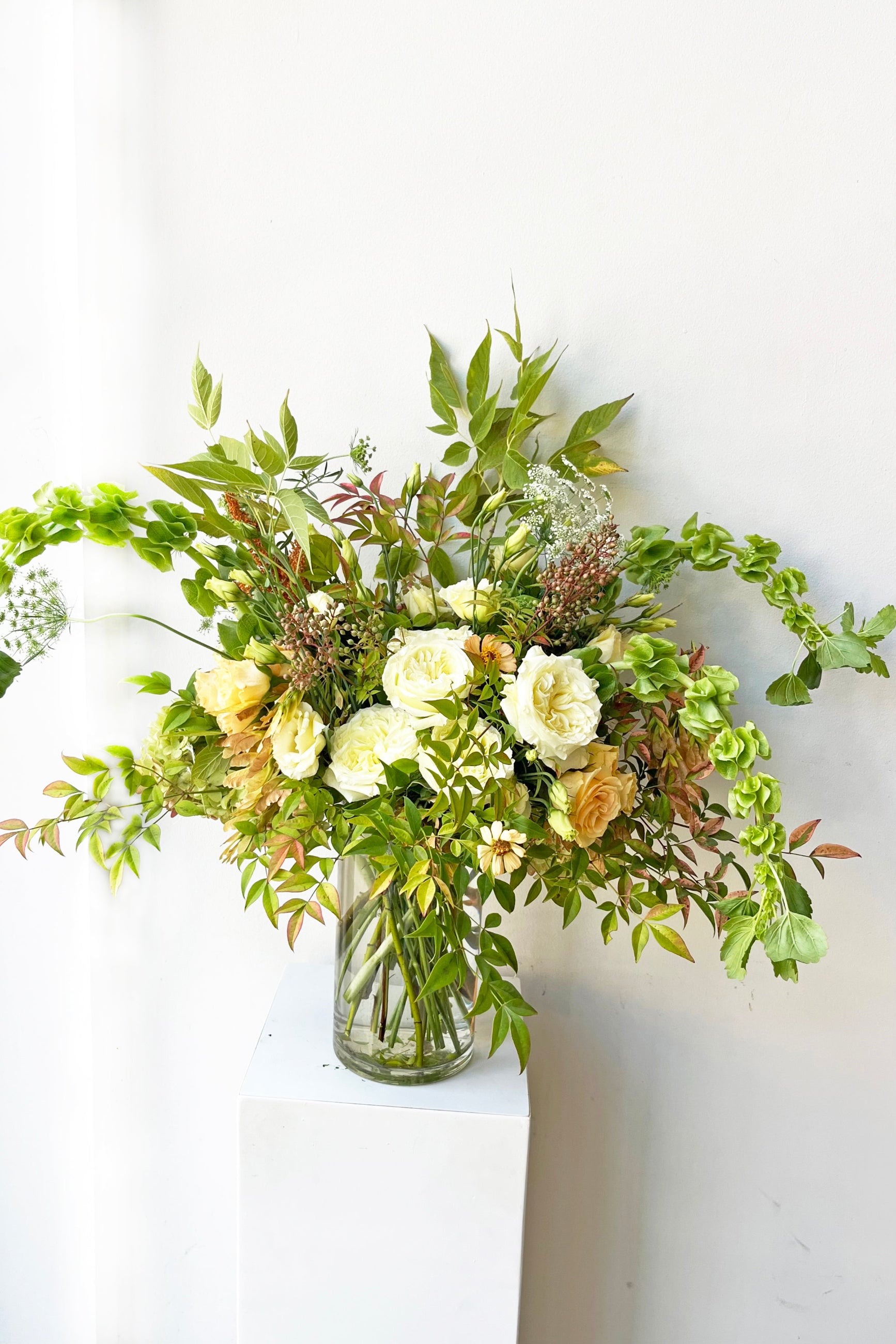 An example of fresh Floral Arrangement Bleached with bells of Ireland, roses and heavy texture from Sprout Home Floral in Chicago ©Sprout Home #size_$160