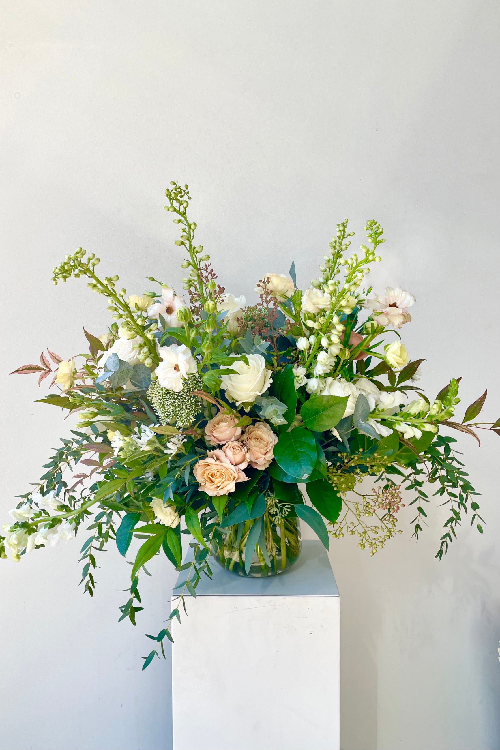 An example of Floral Arrangement Bleached by Sprout Home in Chicago. The arrangement uses primarily white flowers with green foliage. ©Sprout Home #size_$200