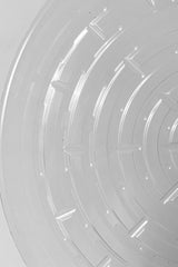 A detailed look at interior ridges of Plastic saucer 12" against white backdrop