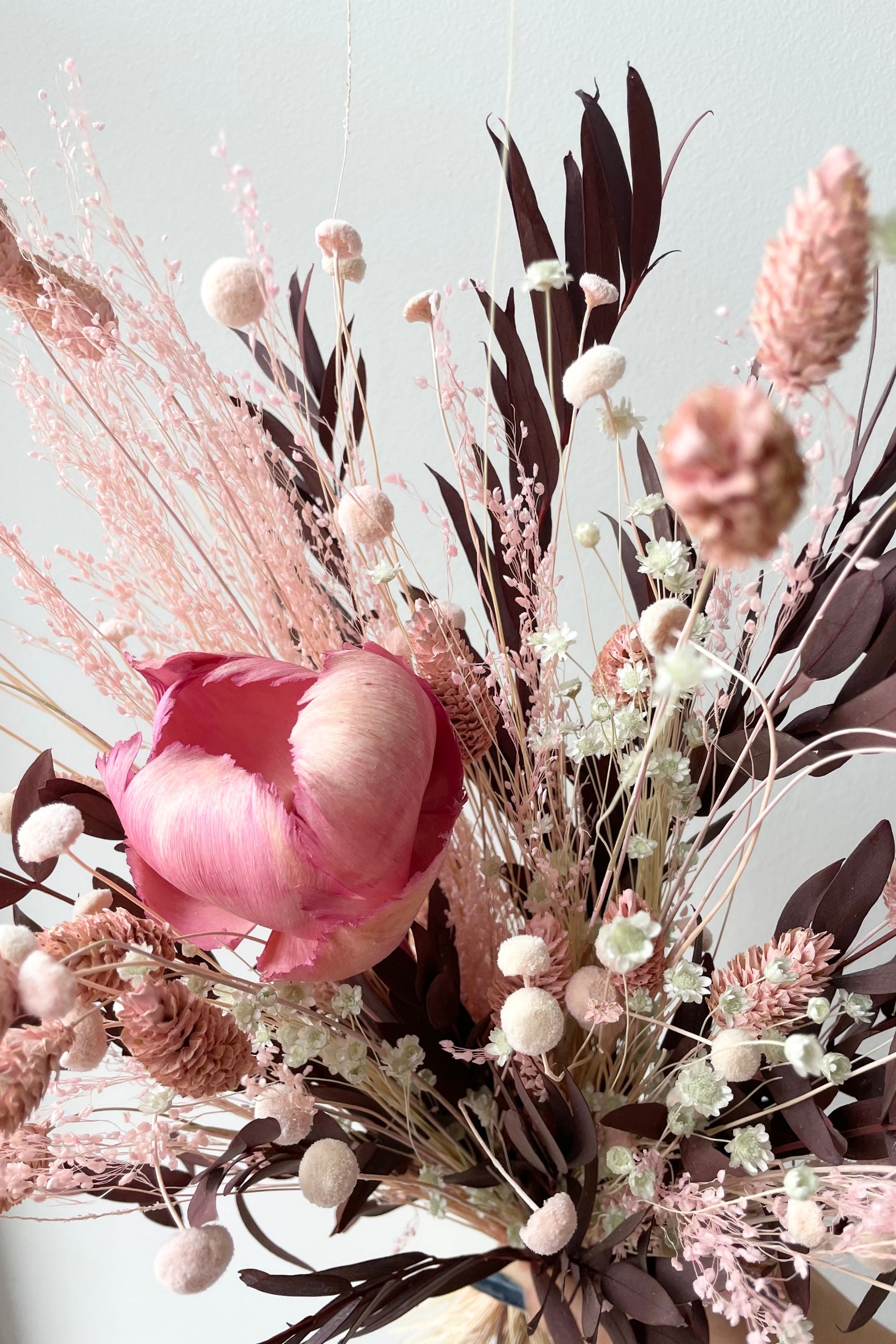 Sprout Home's Chocoberry preserved arrangement detail picture against a white wall. ©Sprout Home #size_$60