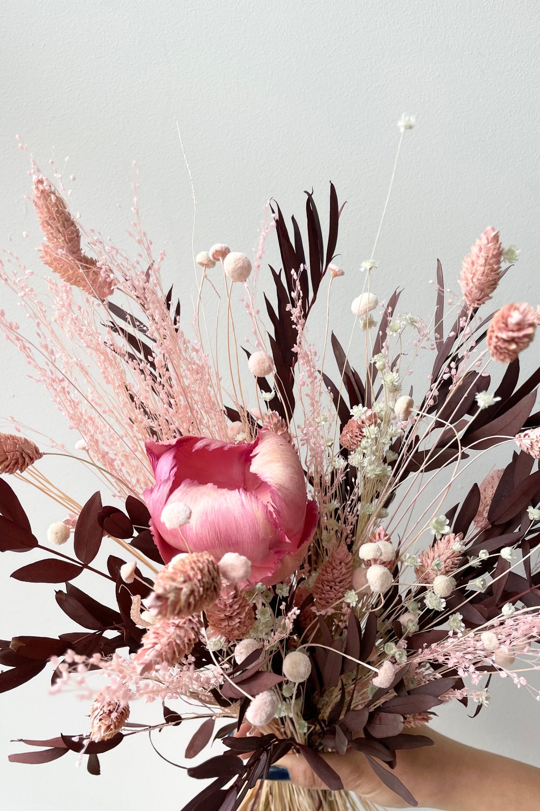 Sprout Home's Chocoberry preserved arrangement detail picture against a white wall. ©Sprout Home #size_$60