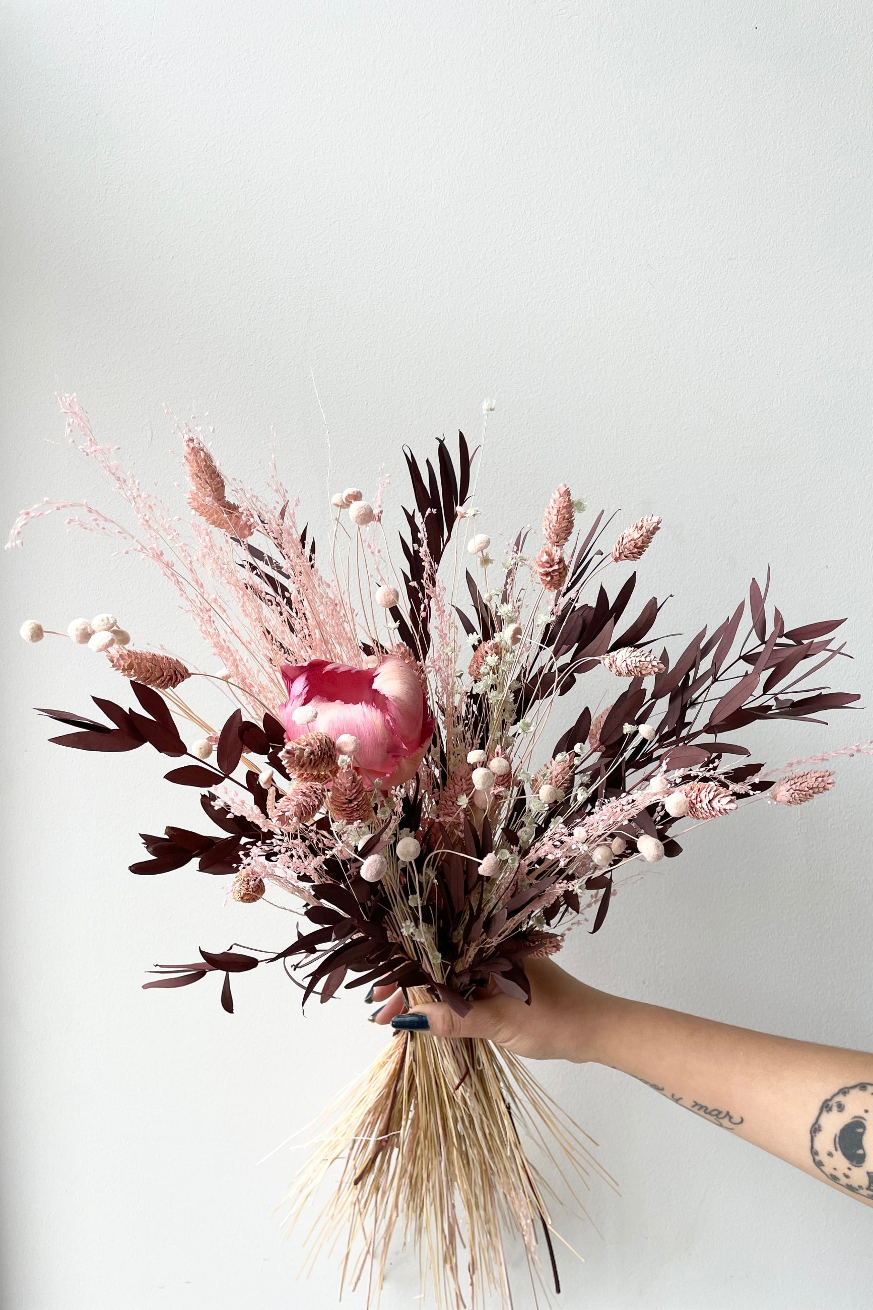 Sprout Home's Chocoberry preserved arrangement against a white wall. ©Sprout Home #size_$60