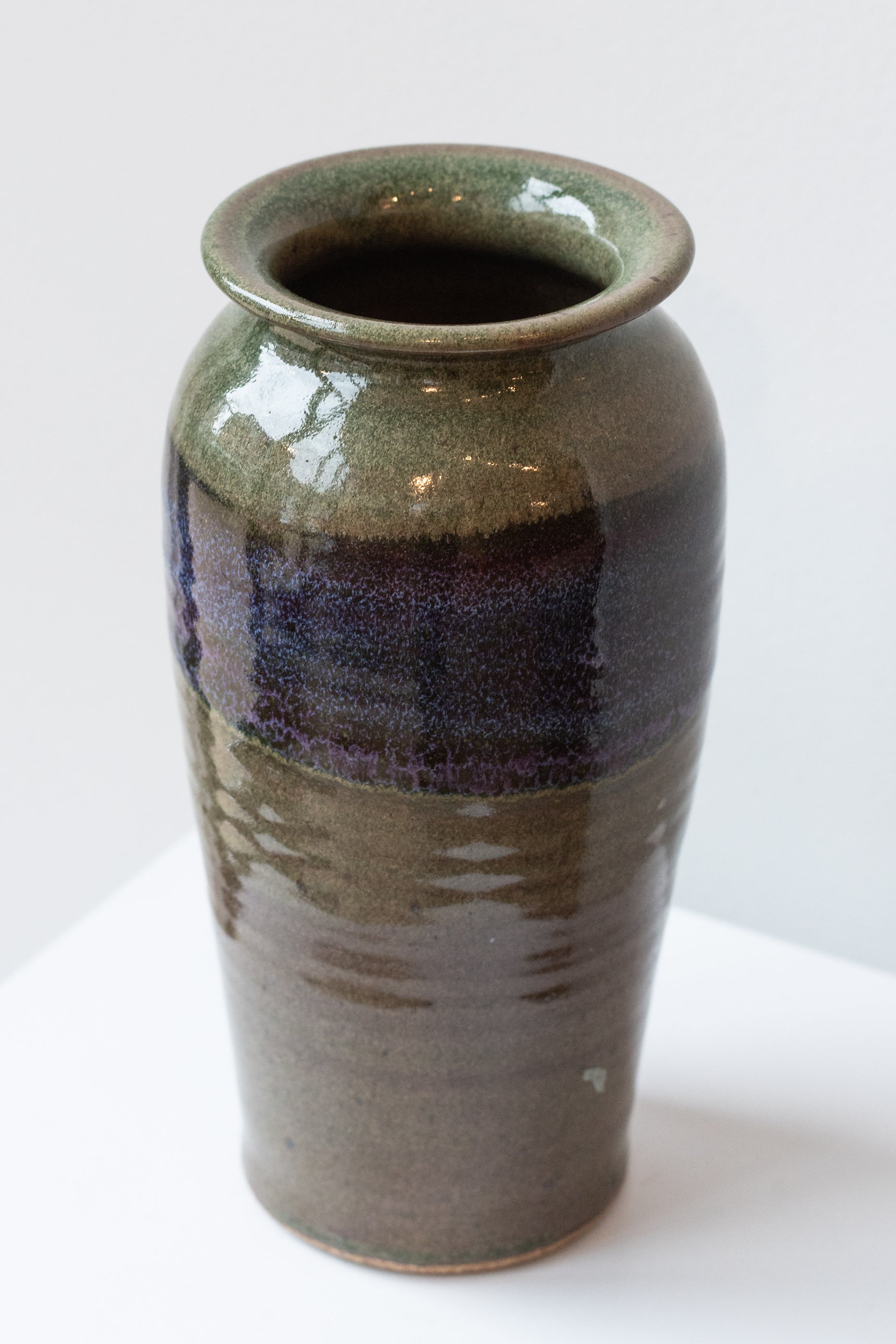 Bruning Pottery moss and lilac glazed tall ceramic vase in front of white background