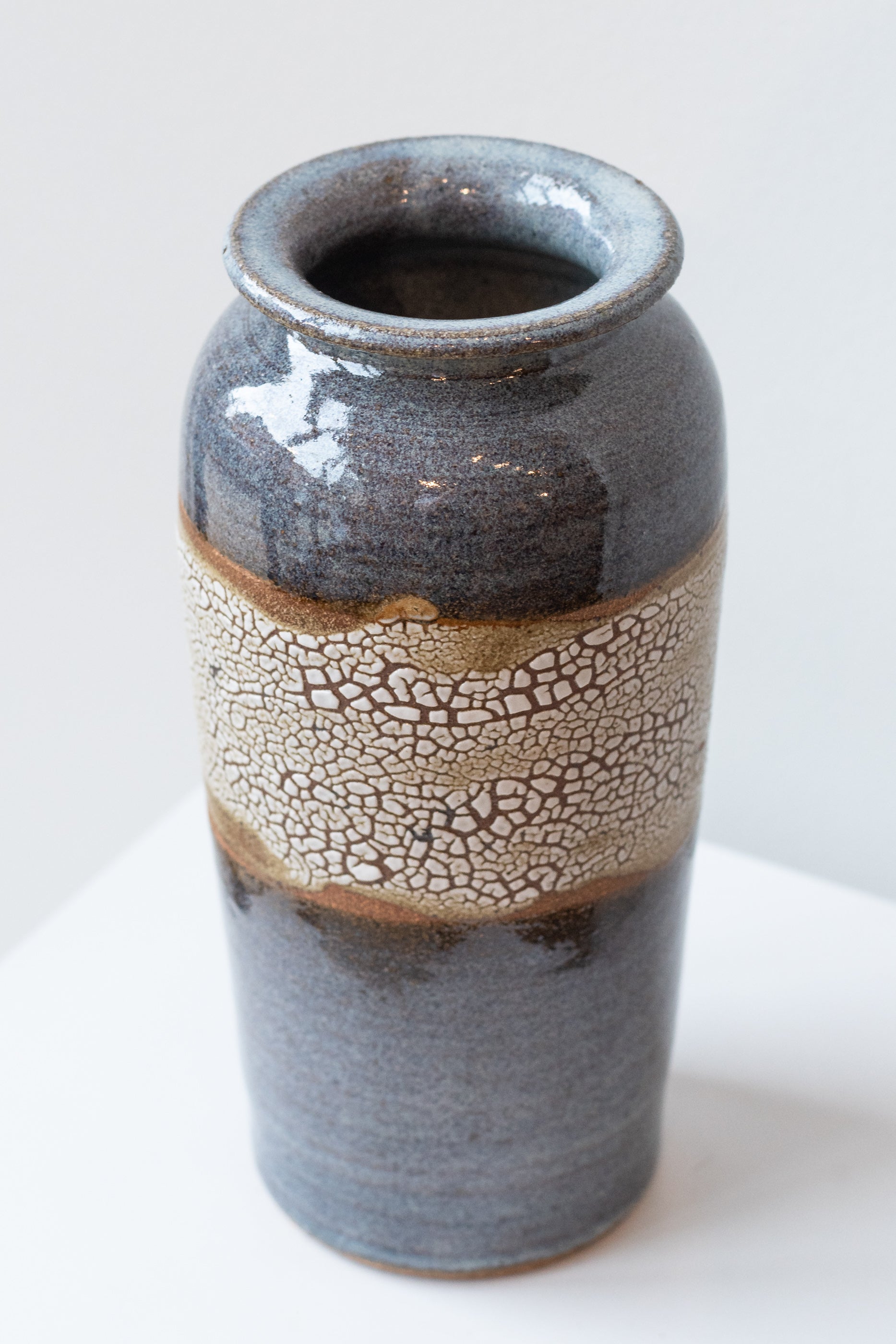 Bruning Pottery "super crackle" glazed tall ceramic vase in front of white background