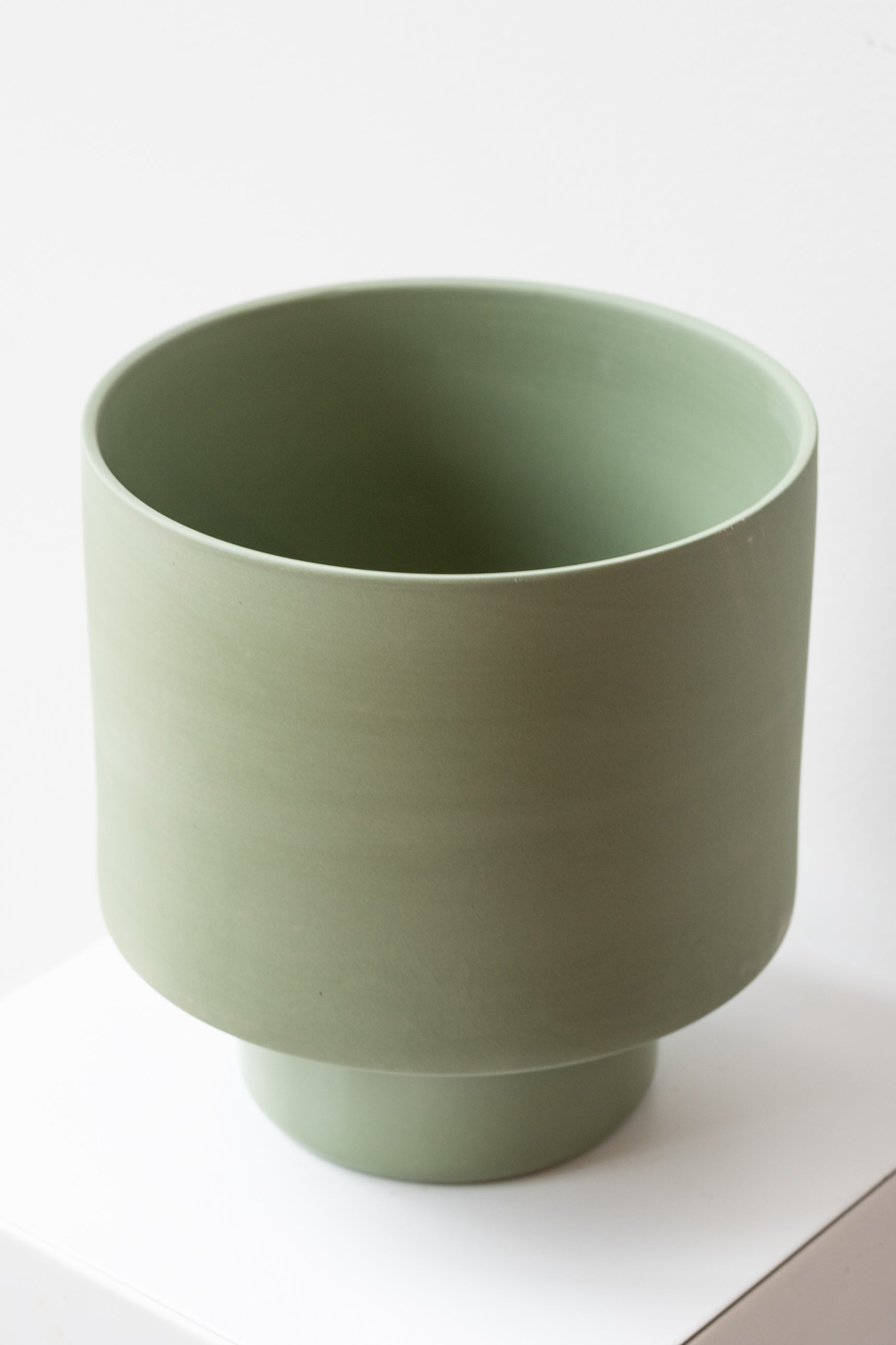 Angus & Celeste Collector's Gro pot olive x-large on white surface in front of white background