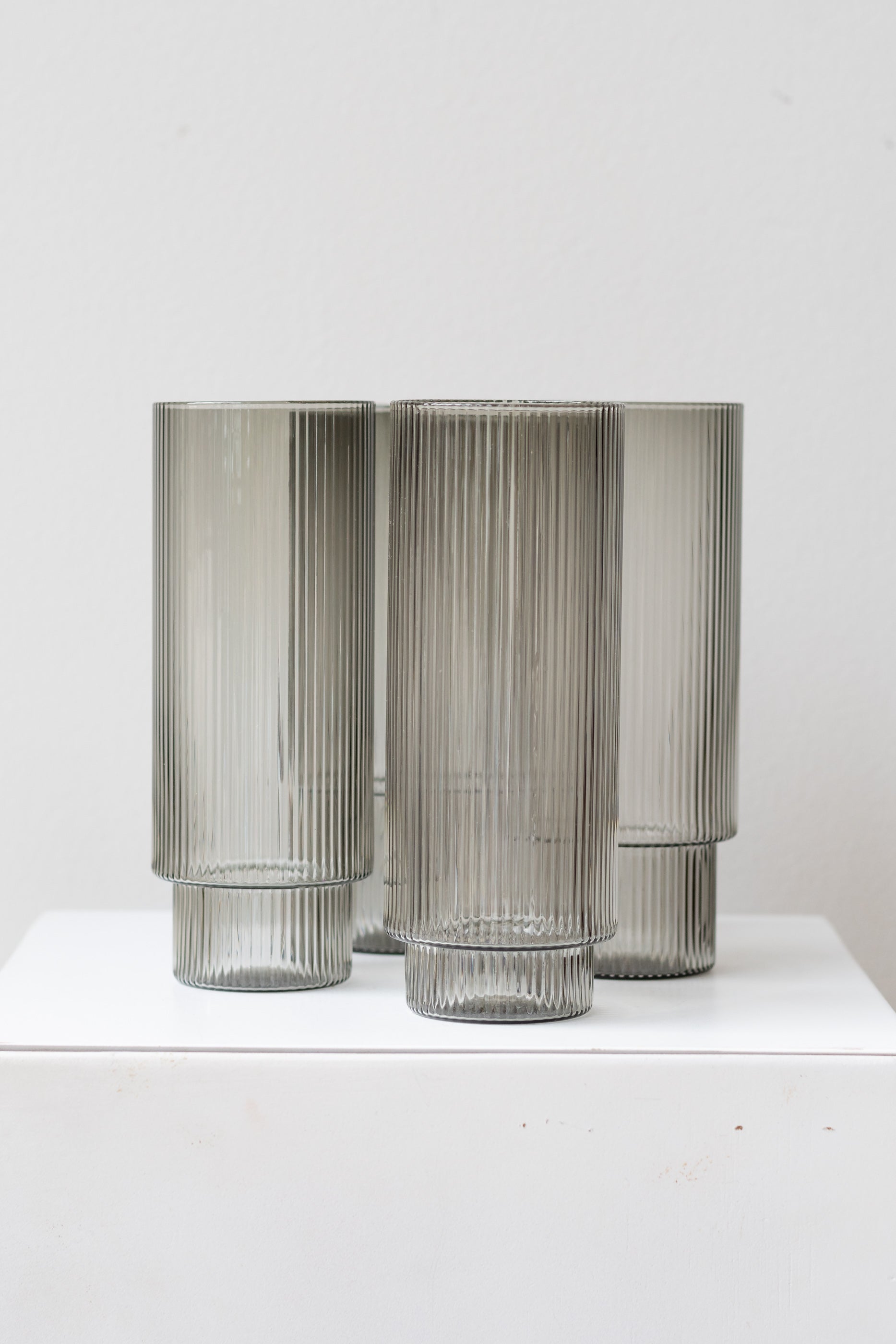Ferm Living Ripple Long Drink Glasses Set of 4 glass smoke on a white surface in a white room