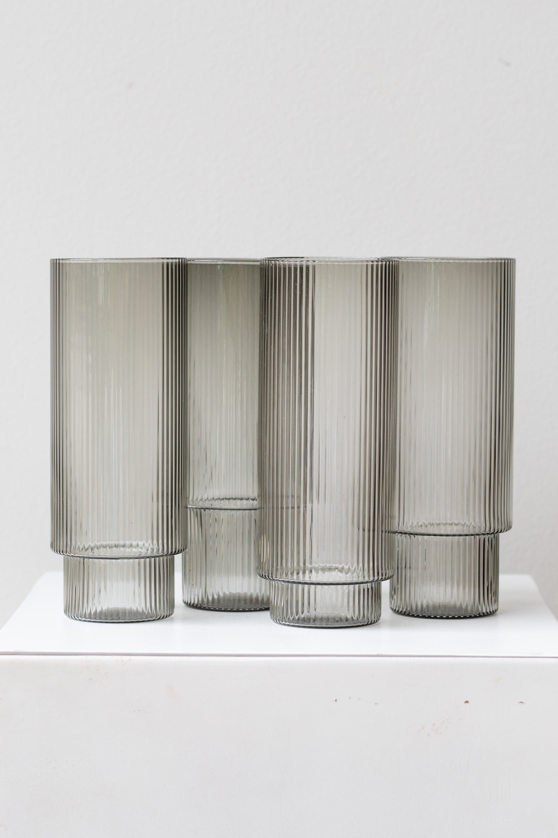 Ferm Living Ripple Long Drink Glasses Set of 4 glass smoke on a white surface in a white room