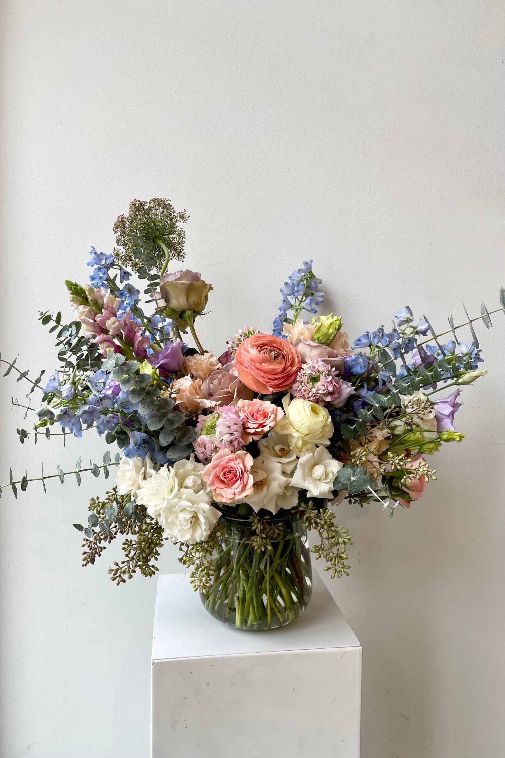 An example of fresh Floral Arrangement Dawn with blue delphinium and huge pink ranunculus from Sprout Home Floral in Chicago ©Sprout Home #size_$200