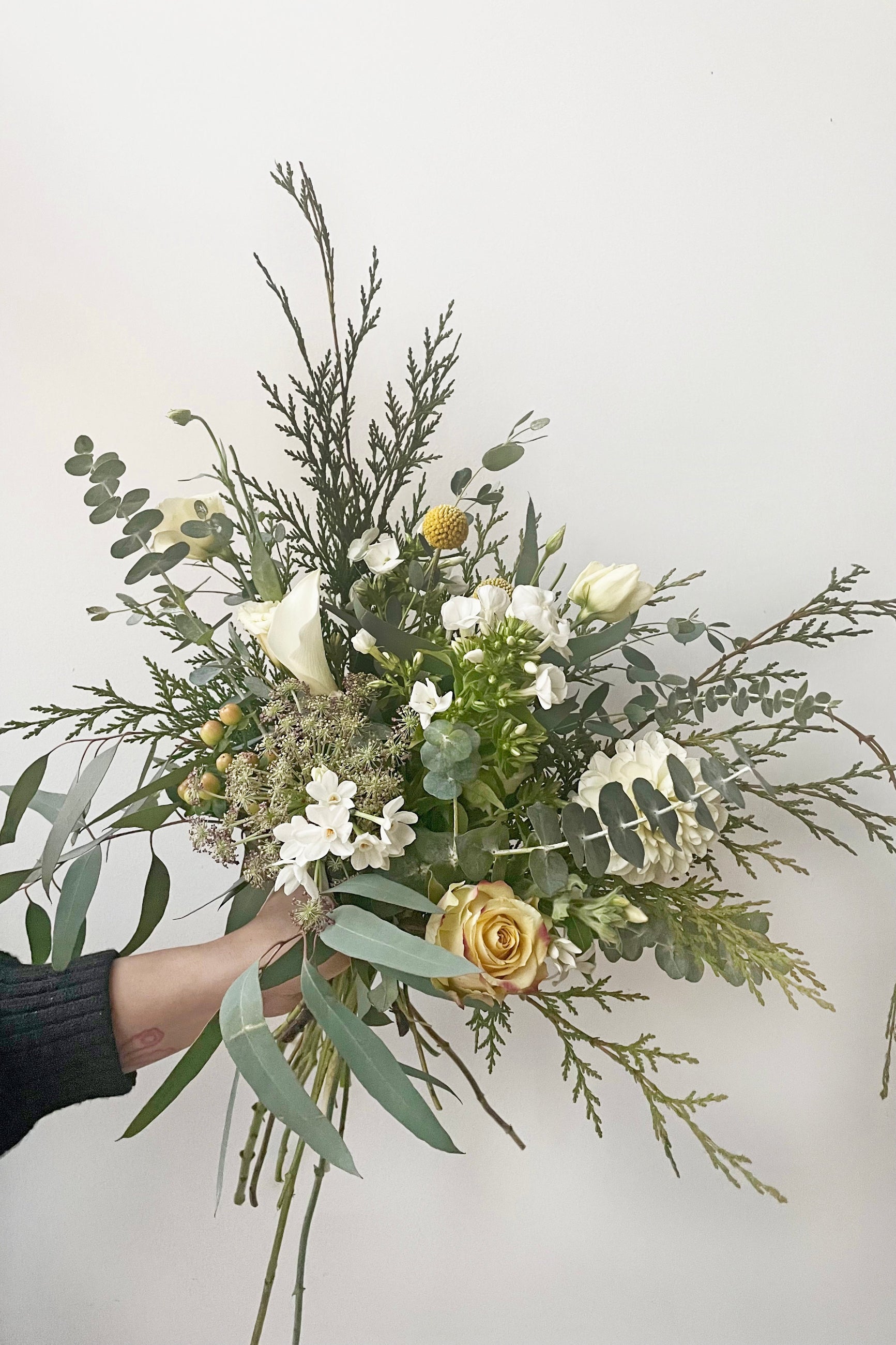 A hand holds an example of fresh Floral Arrangement Eggnog for by Sprout Home Floral in Chicago ©Sprout Home #size_$75