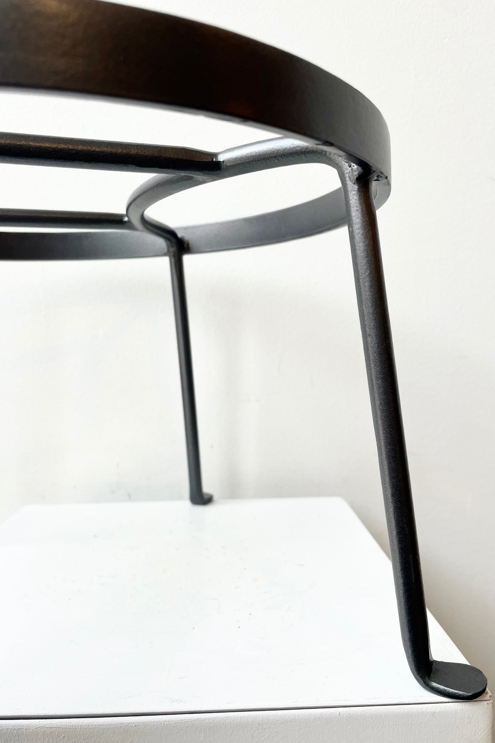 detail of Argyle Plant Stand small against a white wall ©Sprout Home