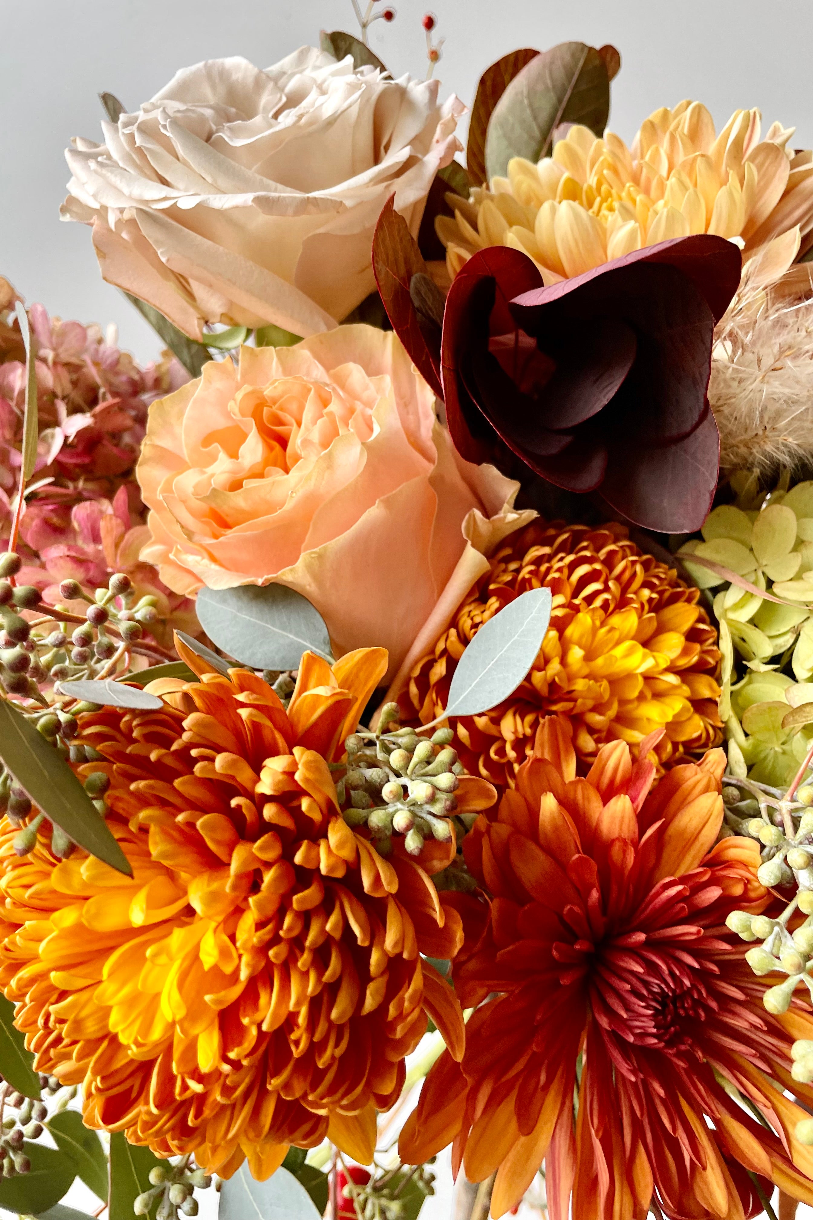 Detail picture of warm colored flowers in Sprout Home's 'Harvest Moon' arrangement. #size_$160