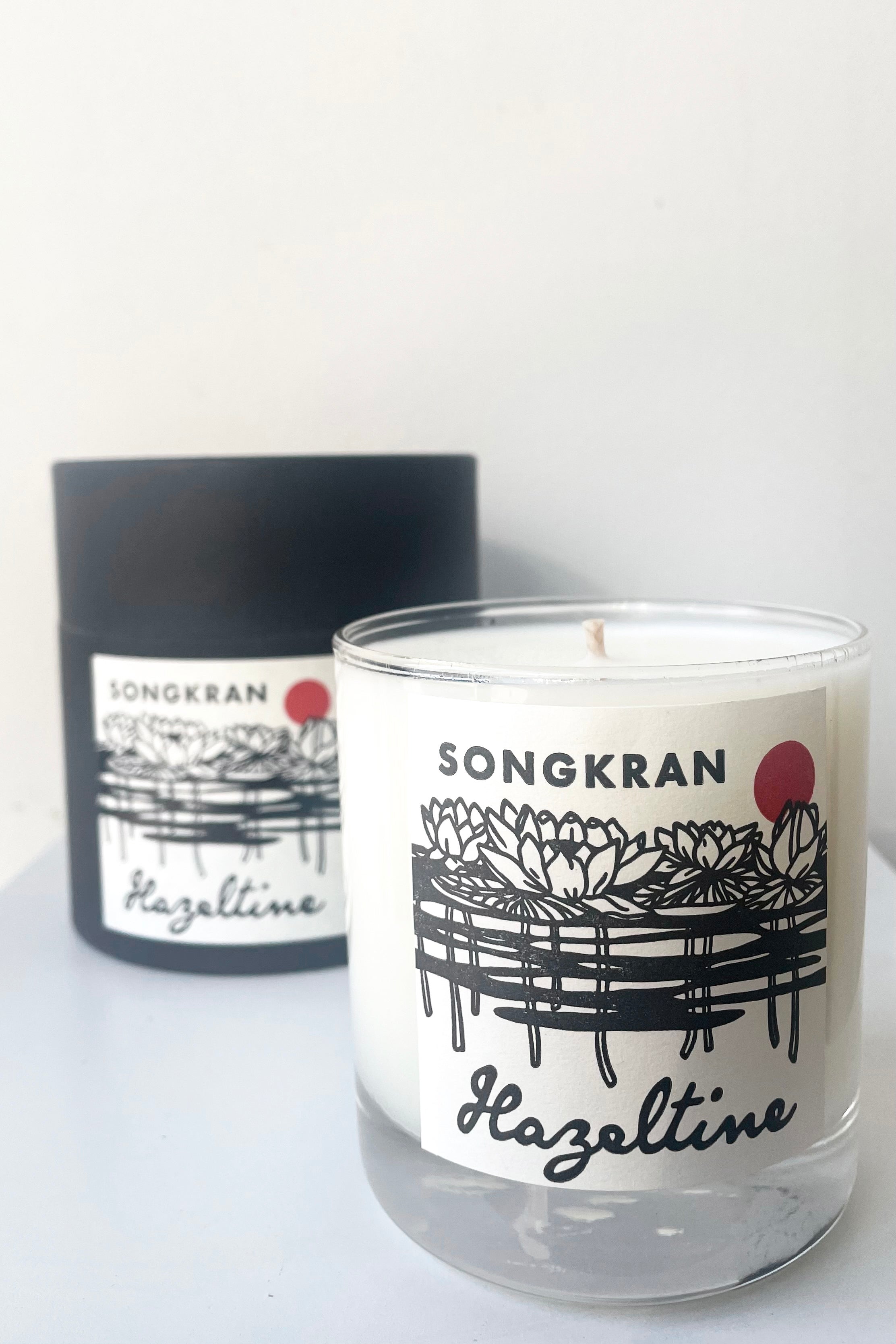A view of the packaging and candle of Hazeltine Candle songkran against white backdrop