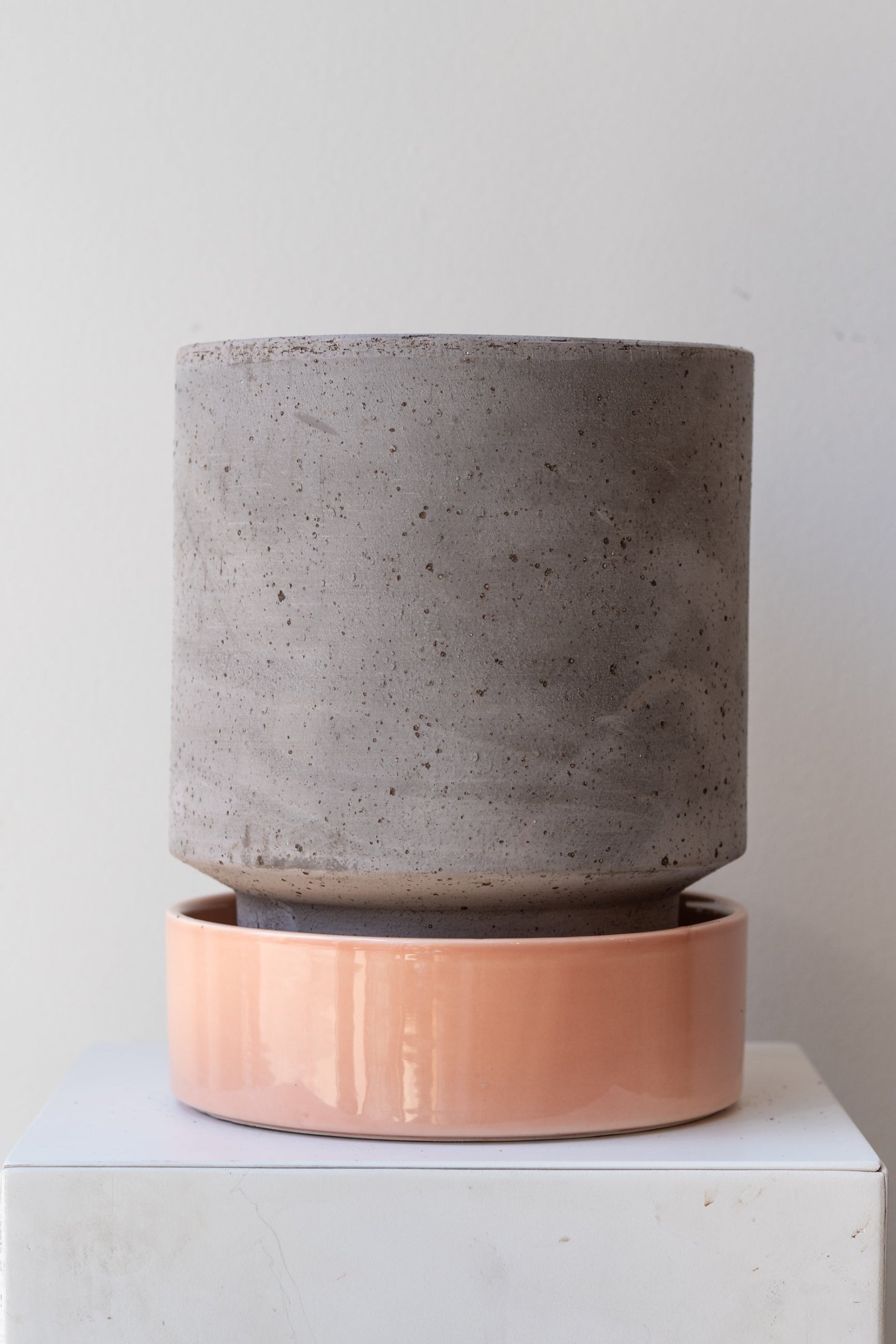 Bergs Potter Hoff Pot & Saucer grey & quartz on a white surface in a white room ©Sprout Home