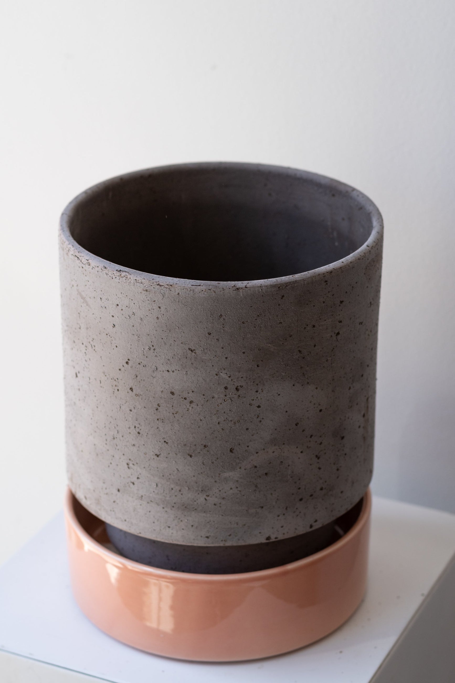 Bergs Potter Hoff Pot & Saucer grey & quartz on a white surface in a white room ©Sprout Home