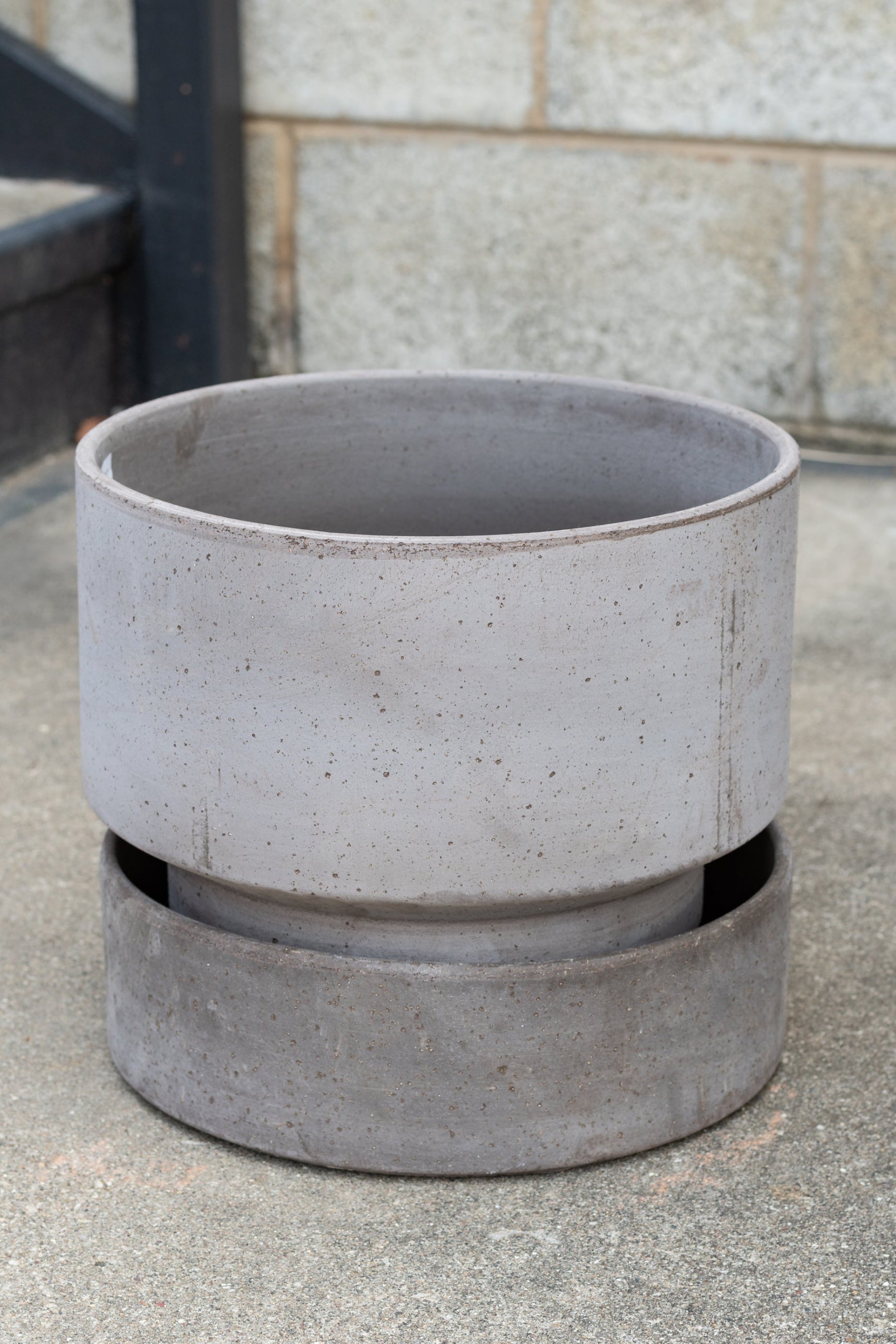 Bergs Potter Hoff Pot & Saucer grey 11.8” in front of concrete brick wall ©Sprout Home