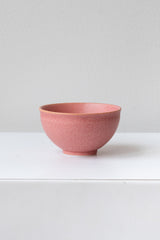 Hot pink ishi teacup by Miya Company Inc sits on a white surface in a white room