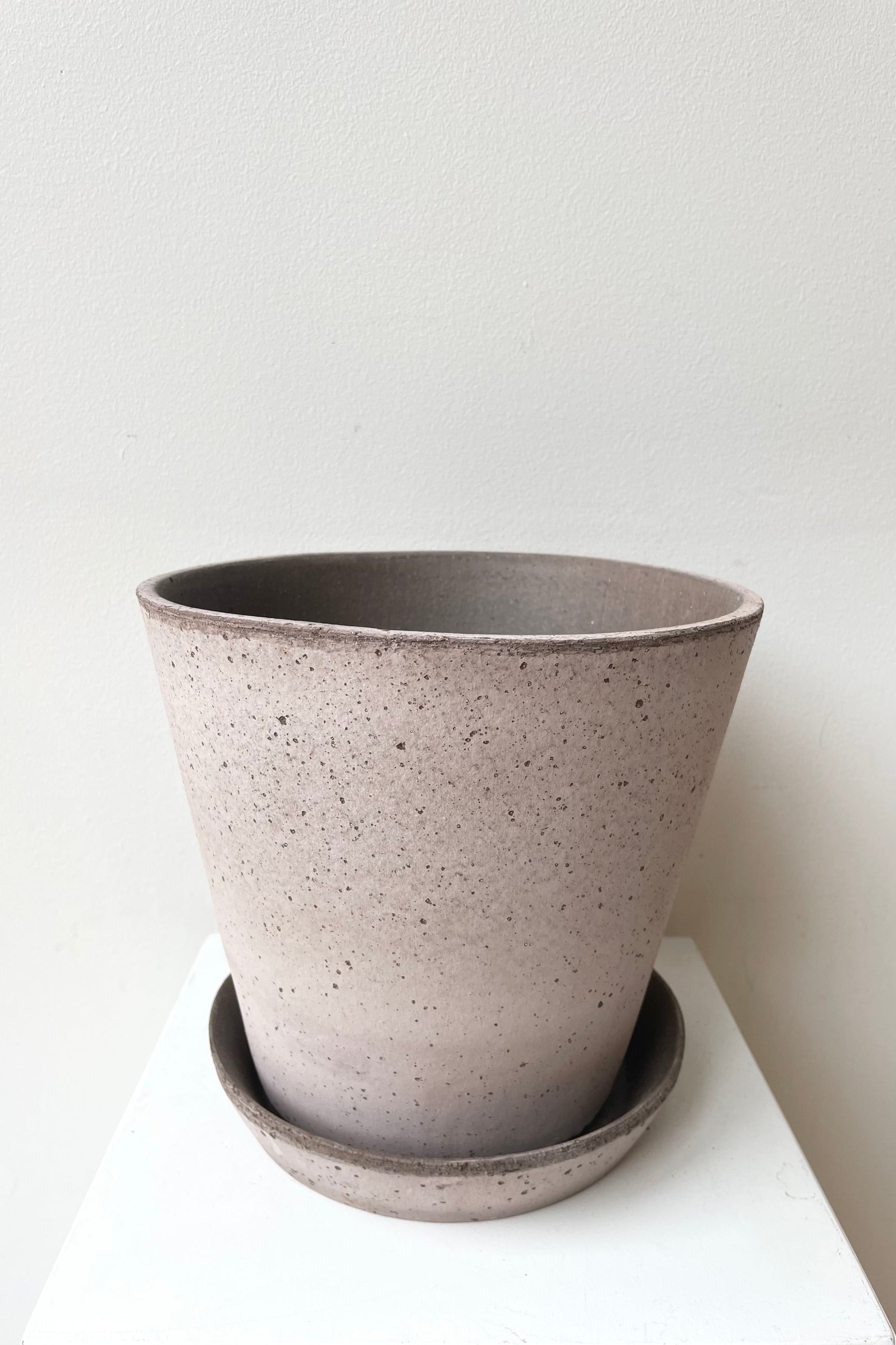Julie Pot & Saucer grey 8.3” against a white wall ©Sprout Home