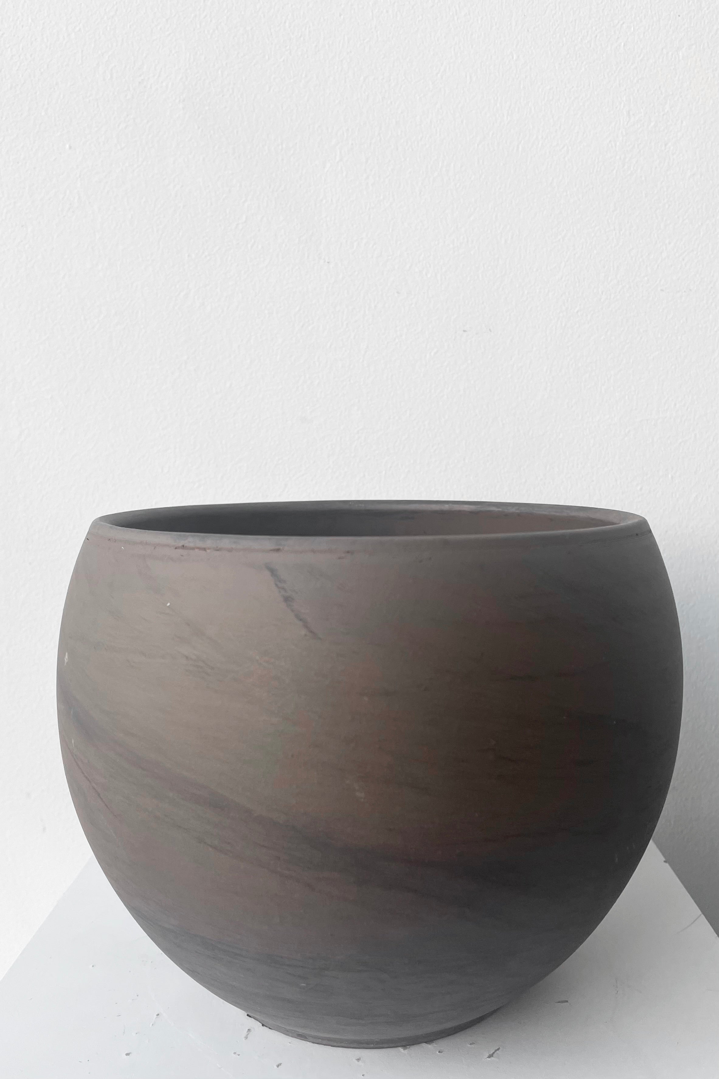 A frontal view of Luna Sphere Pot basalt 7.75" against white backdrop