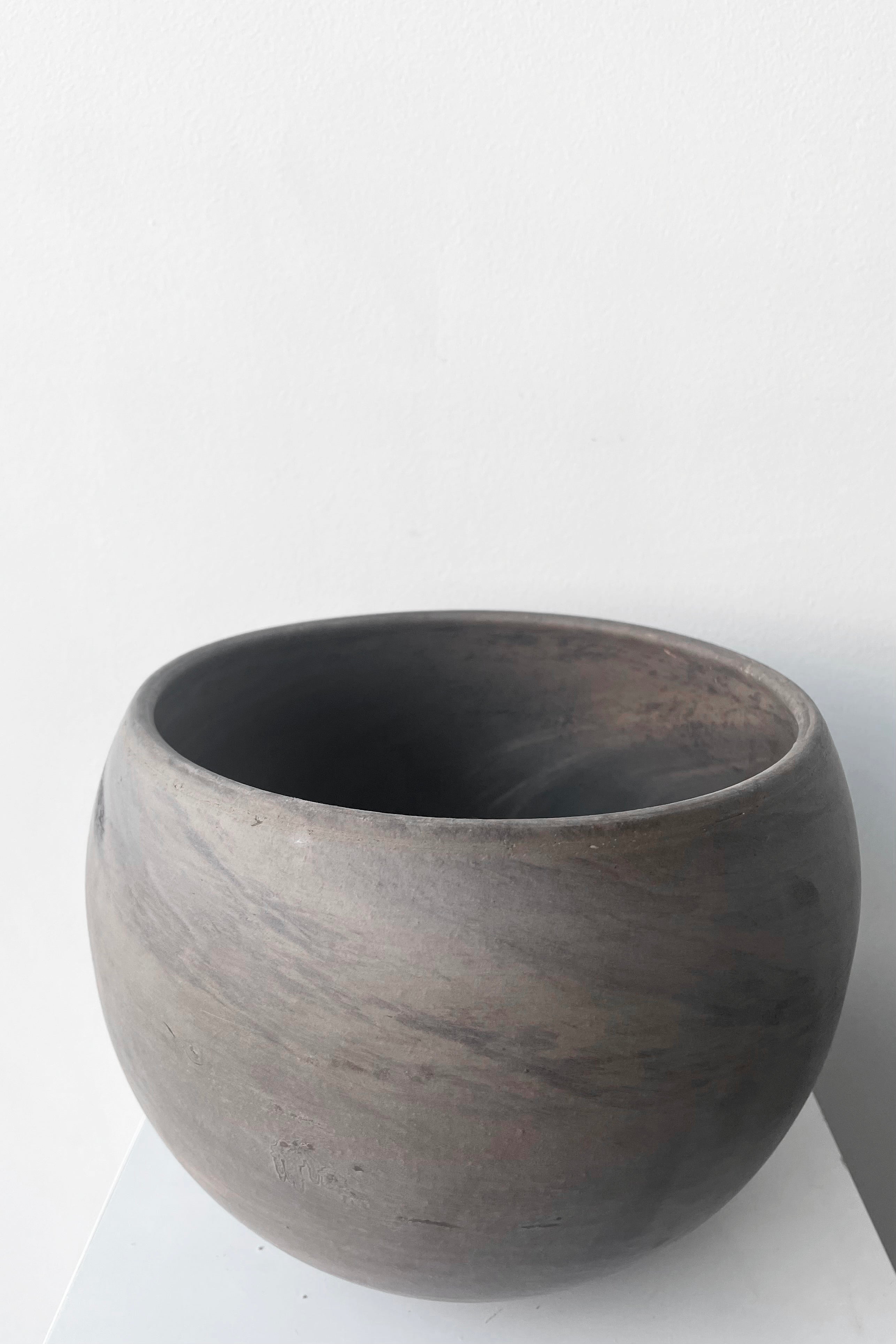 A slight overhead view of Luna Sphere Pot basalt 9" against white backdrop