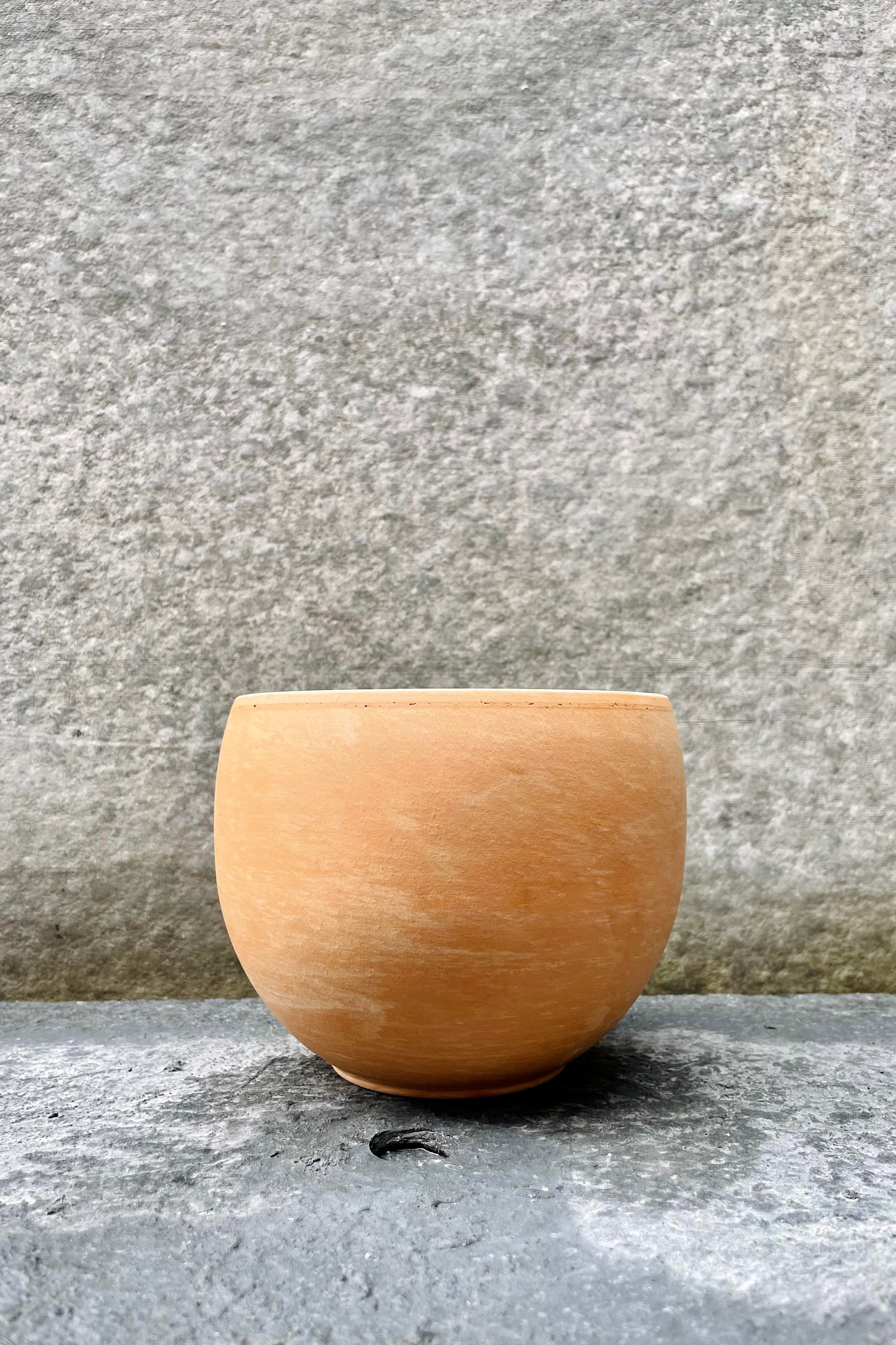 The Luna Sphere pot sits against a grey backdrop at 5.25 inches in a light marble shade.