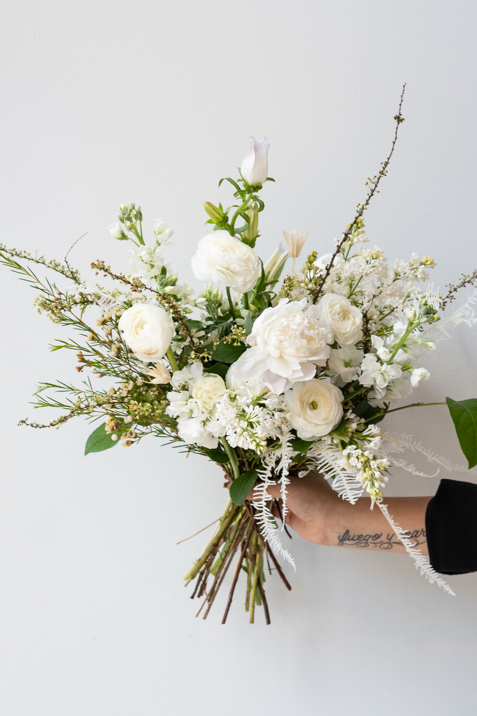 An example of Floral Arrangement Bleached by Sprout Home in Chicago. The arrangement uses primarily white flowers with green foliage. ©Sprout Home #size_$130