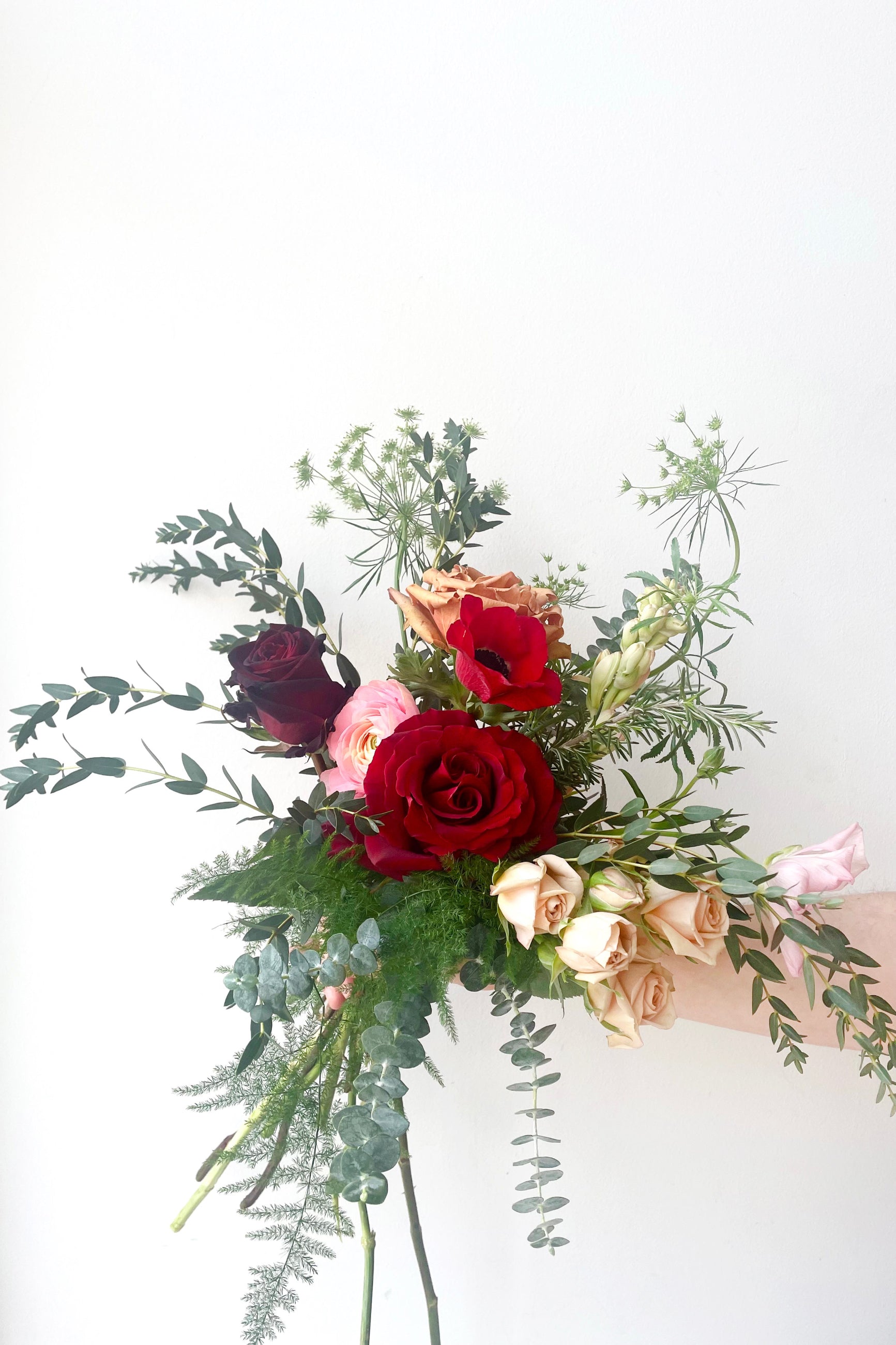 A hand holds an example of fresh Floral Arrangement Modern Lovefrom Sprout Home Floral in Chicago for Valentine's Day ©Sprout Home #size_$75