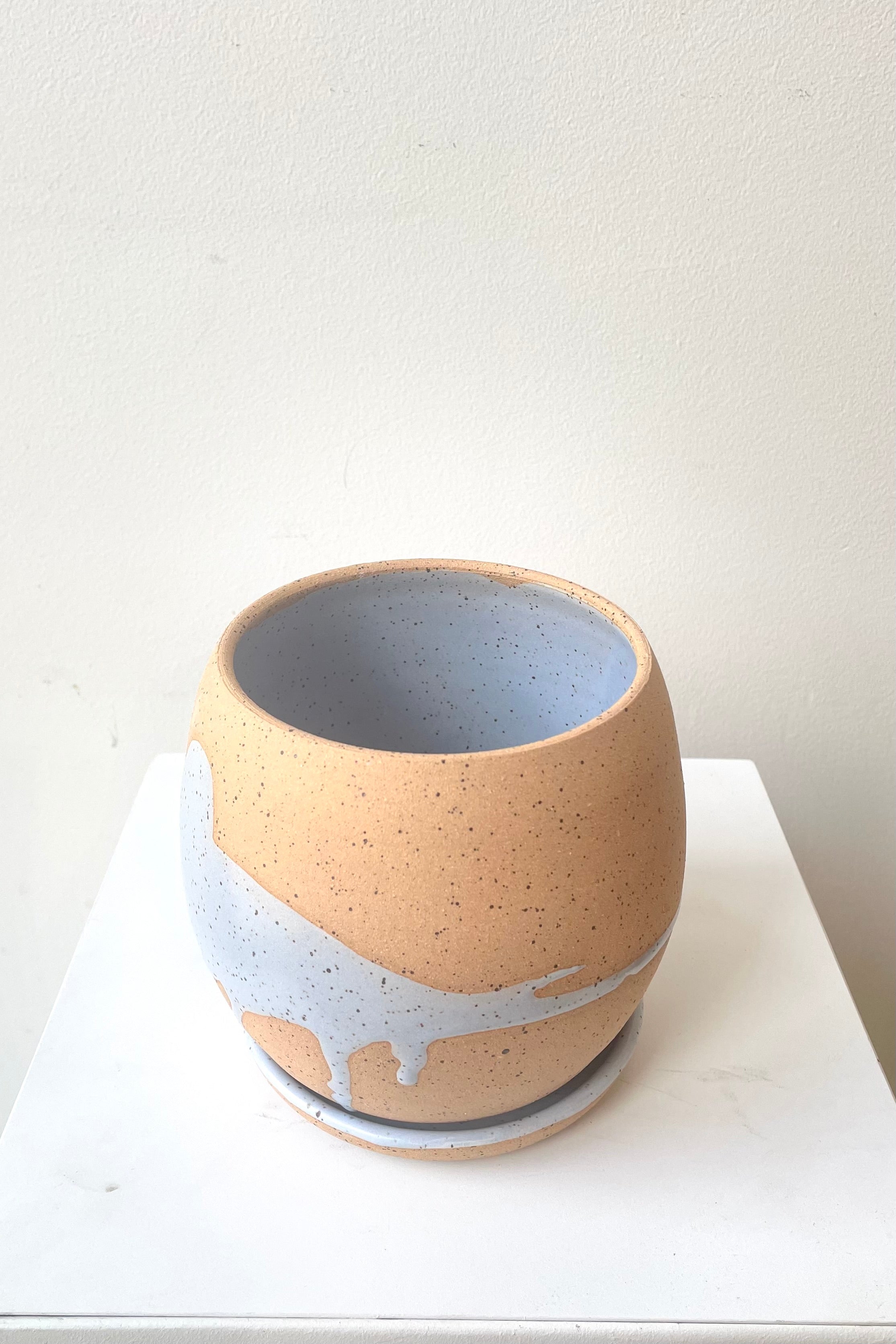 An over-the-lip view of the 4.5" orb pot and saucer in blue against a white backdrop