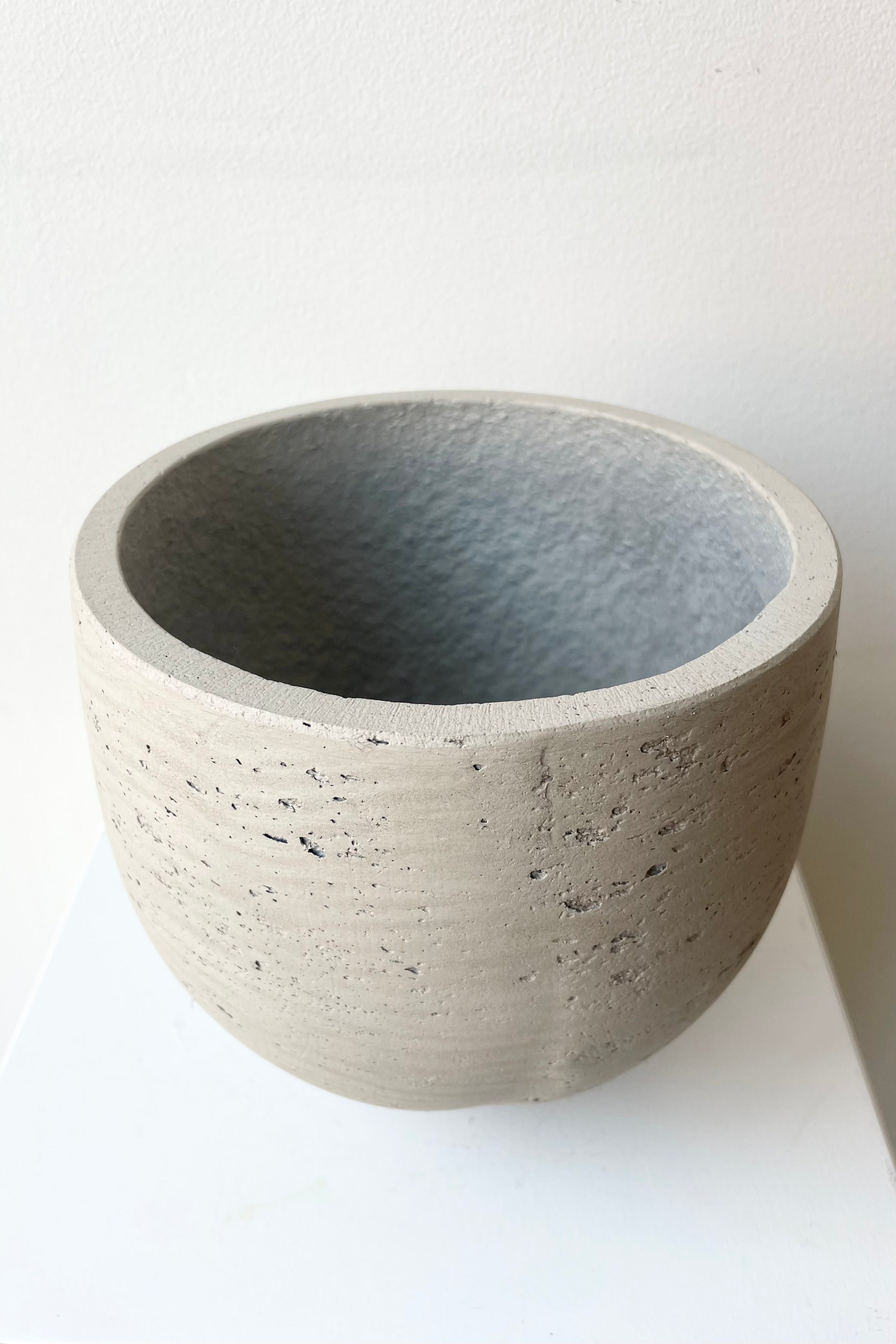 Mini Orb Pot Detail of the top of the Grey Washed Small against a white wall