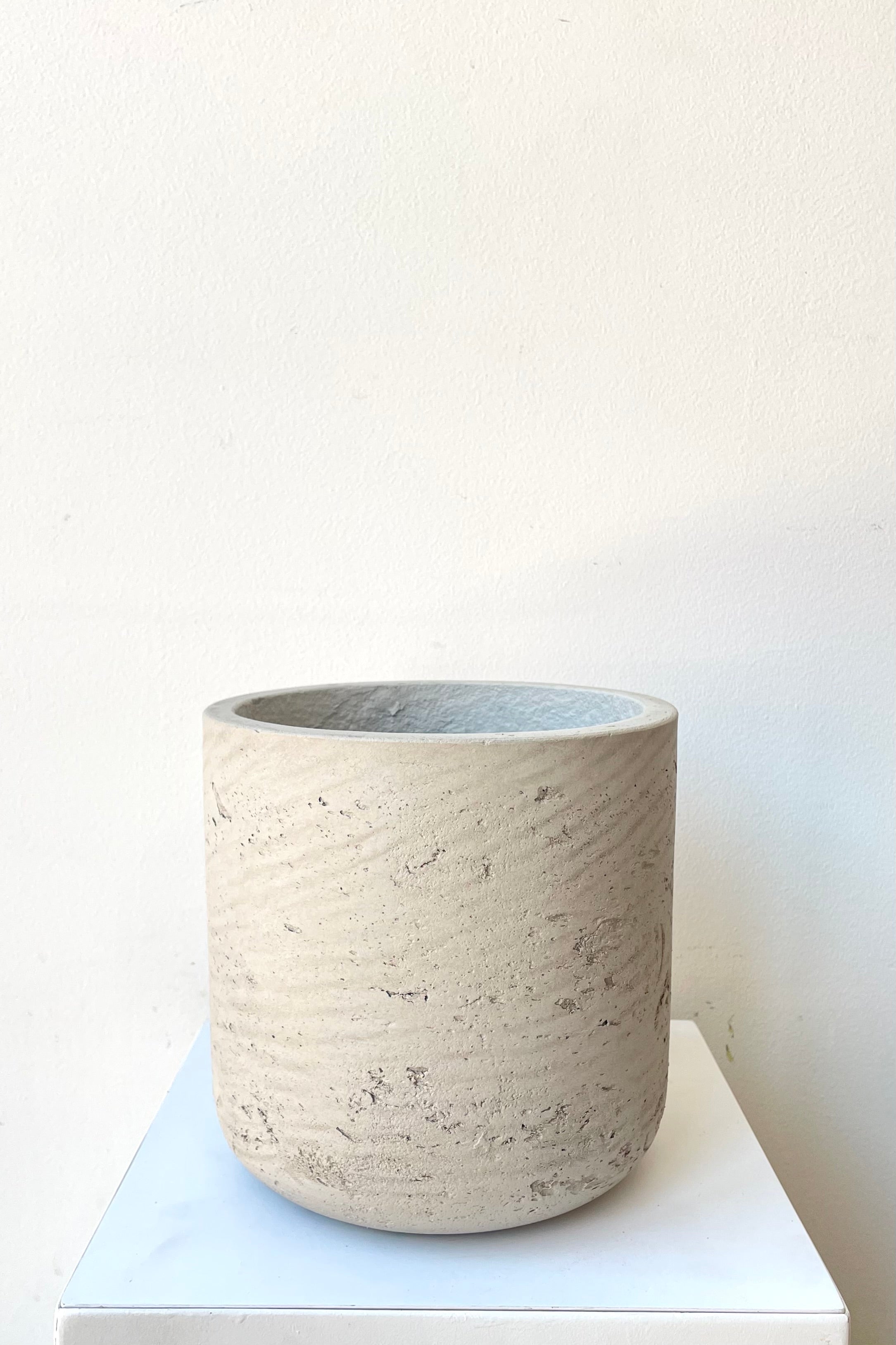 A slight over-the-lip view of the grey Charlie pot in medium against a white backdrop