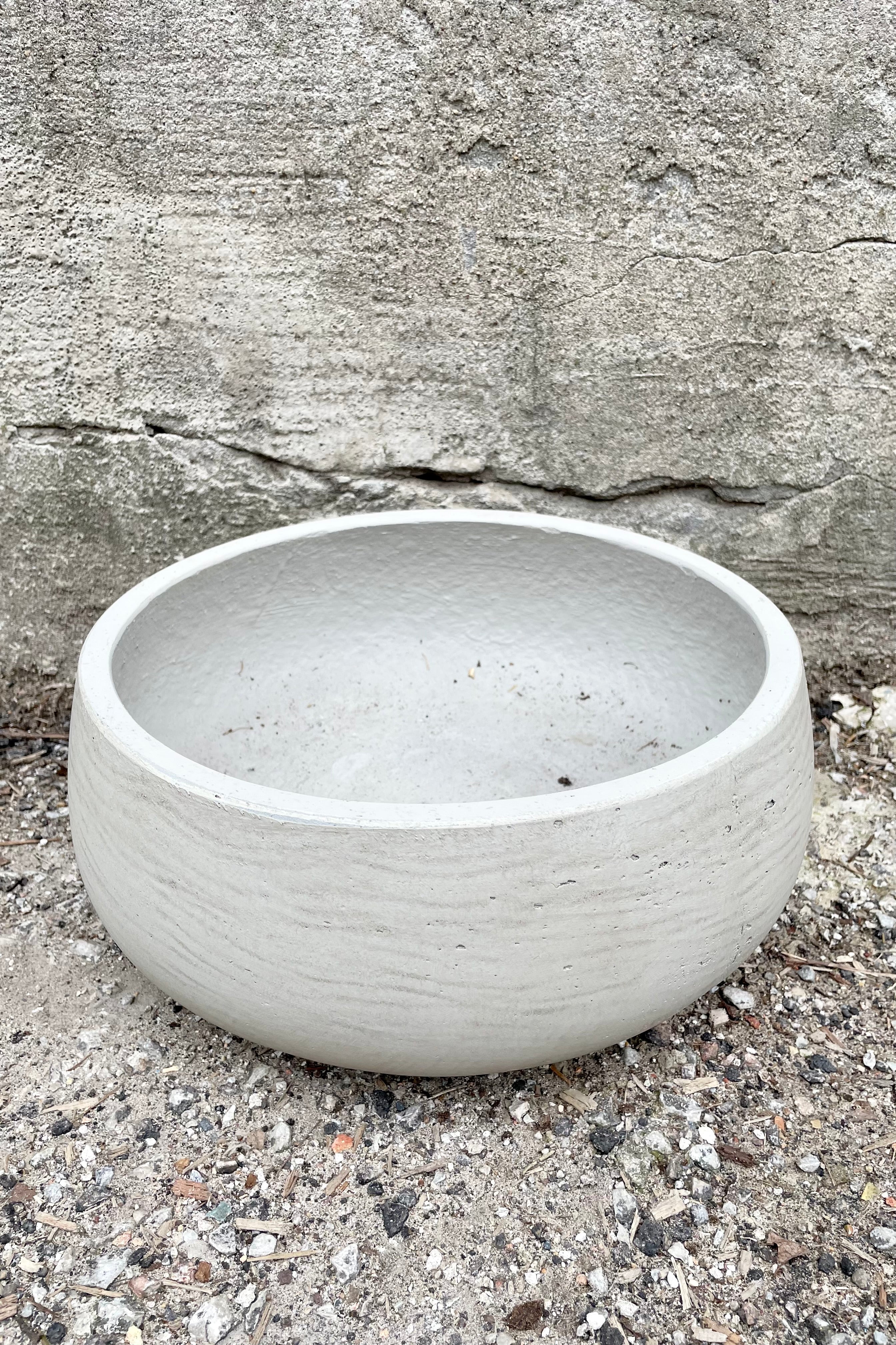 Detail of top of Eileen Pot grey washed medium against a grey wall