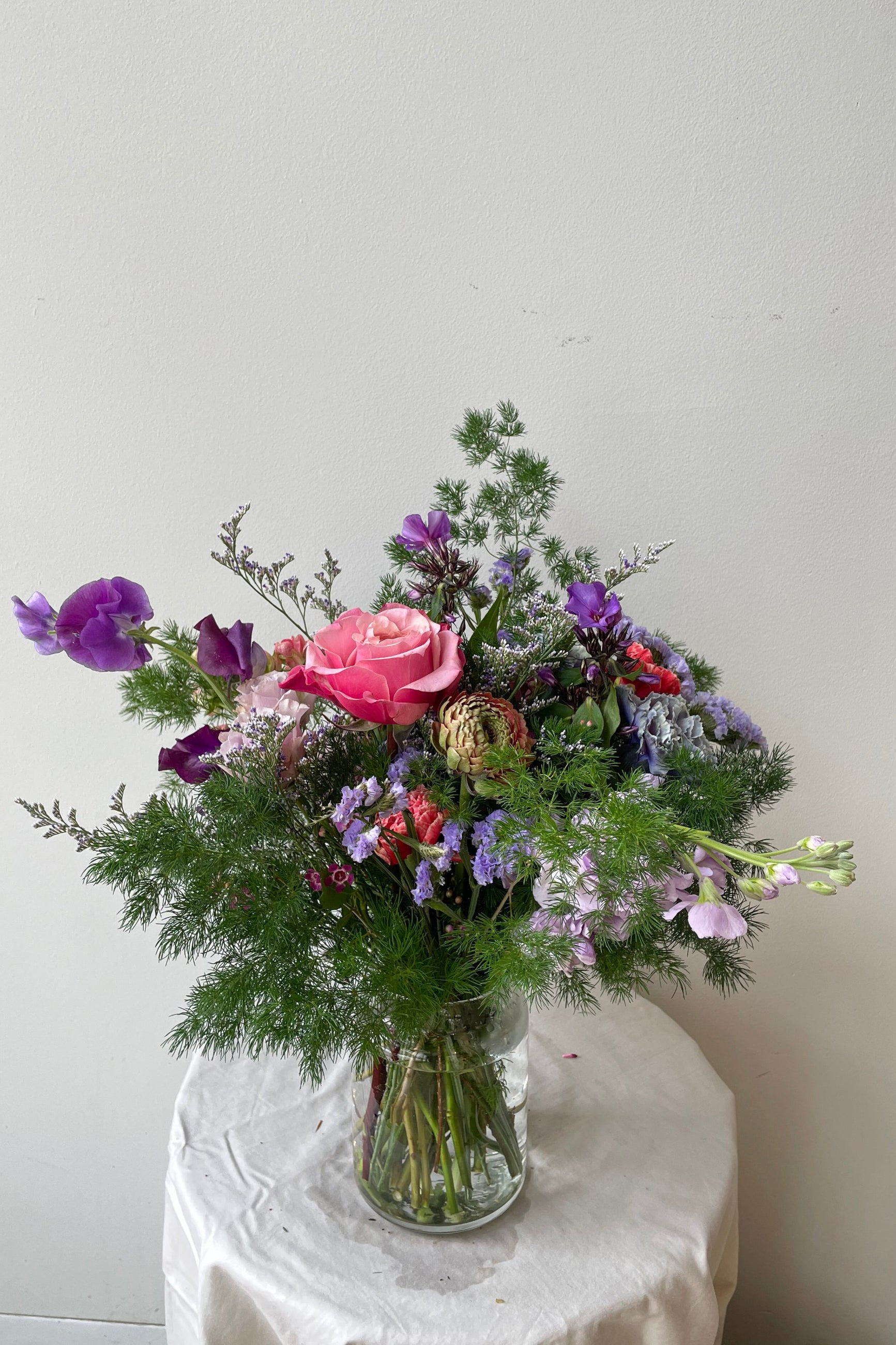 a custom pastel arrangement by Sprout Home featuring asparagus fern ©Sprout Home #size_$75