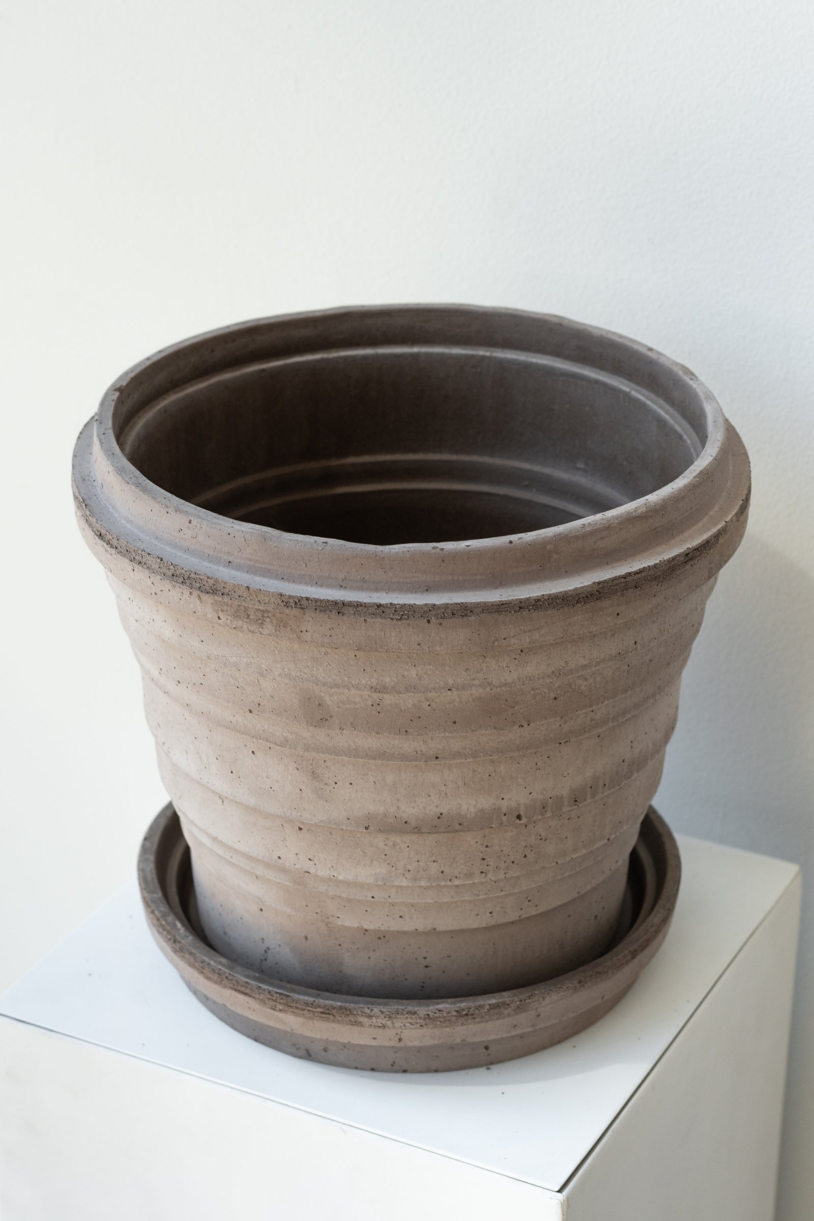Grey 9.8 inch Planets Pot by Bergs Potter on a white surface in a white room