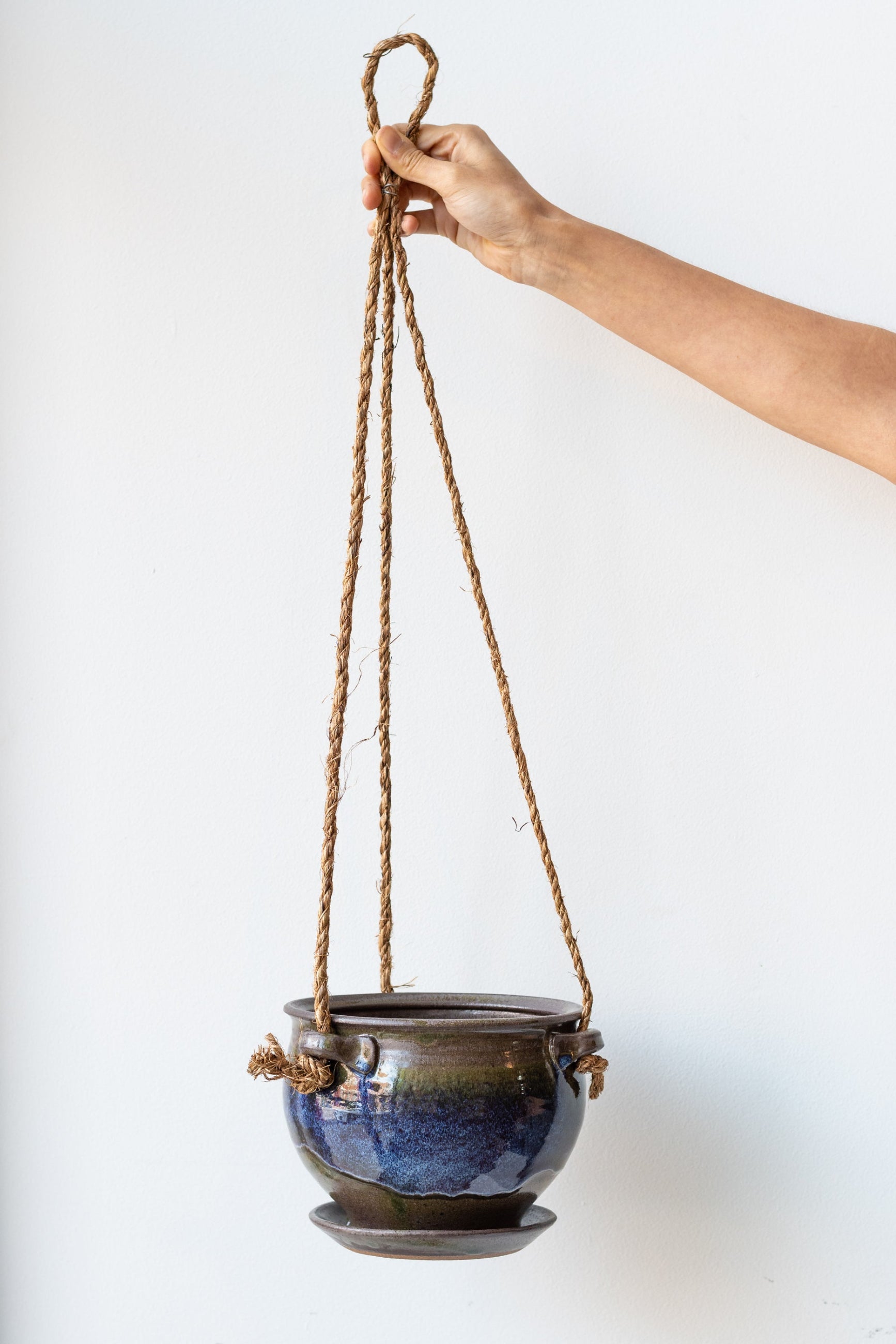 Bruning Pottery Hanging Planter moss & lilac glaze - 6" held in front of white wall ©Sprout Home